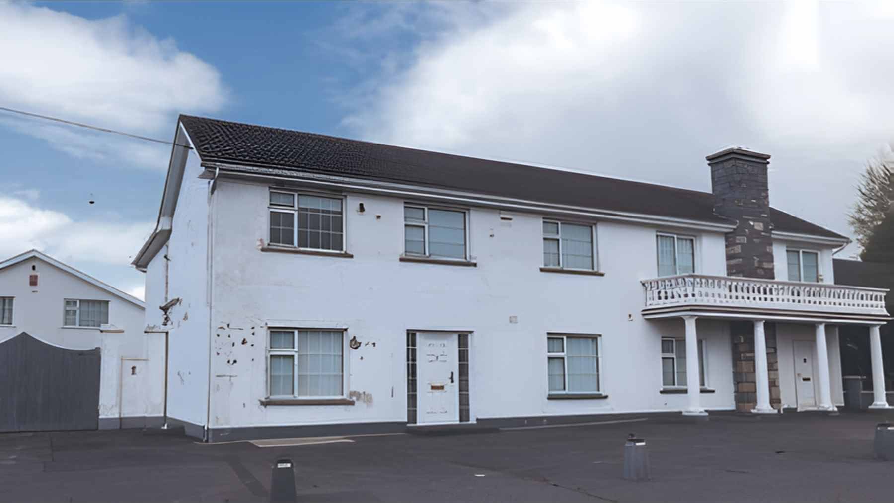 A large two-story house sitting on a very small plot of land, illustrating the limited space available for a septic system.