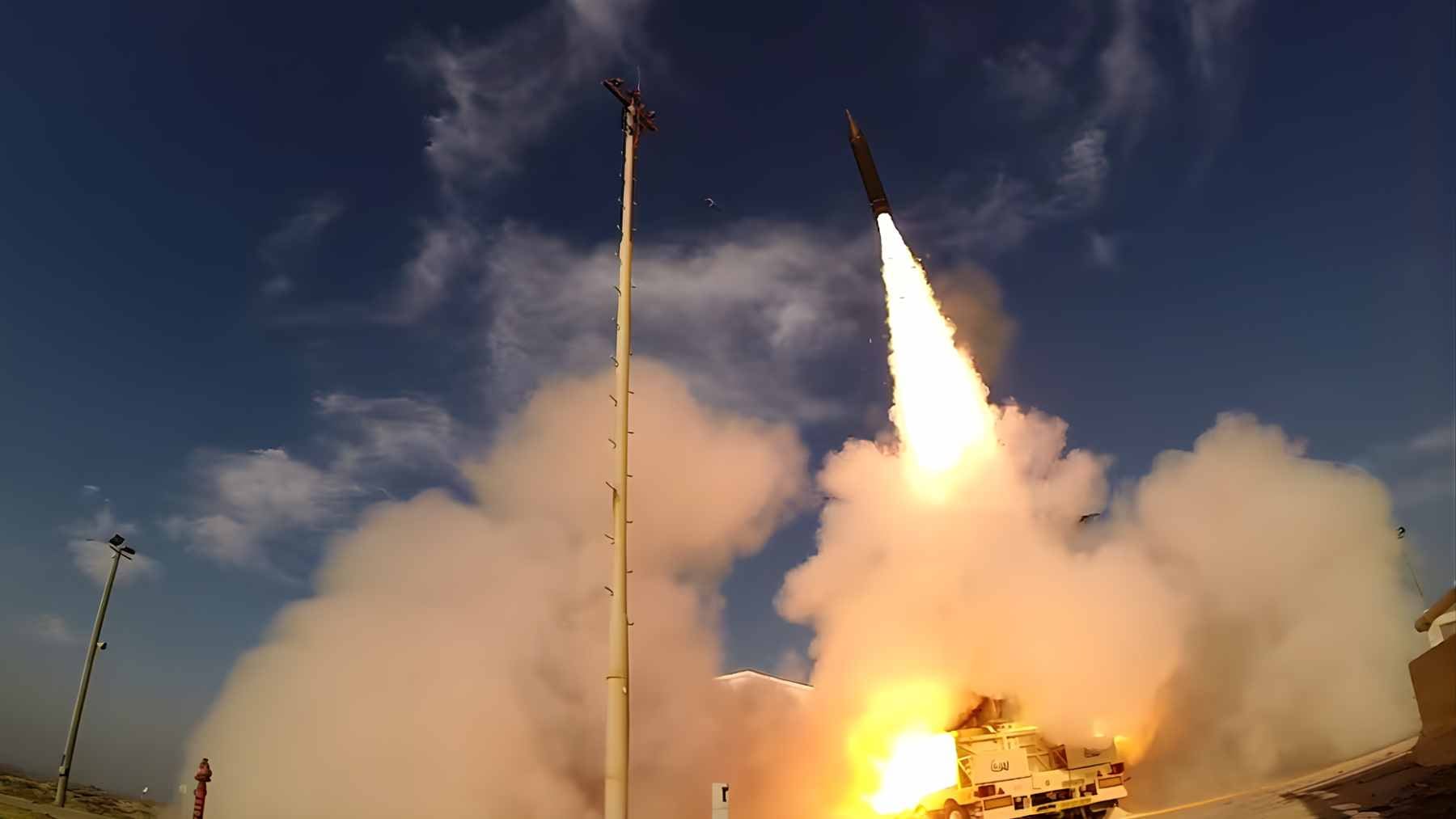 An Arrow 3 interceptor missile launching into the sky from a military defense facility in Israel.
