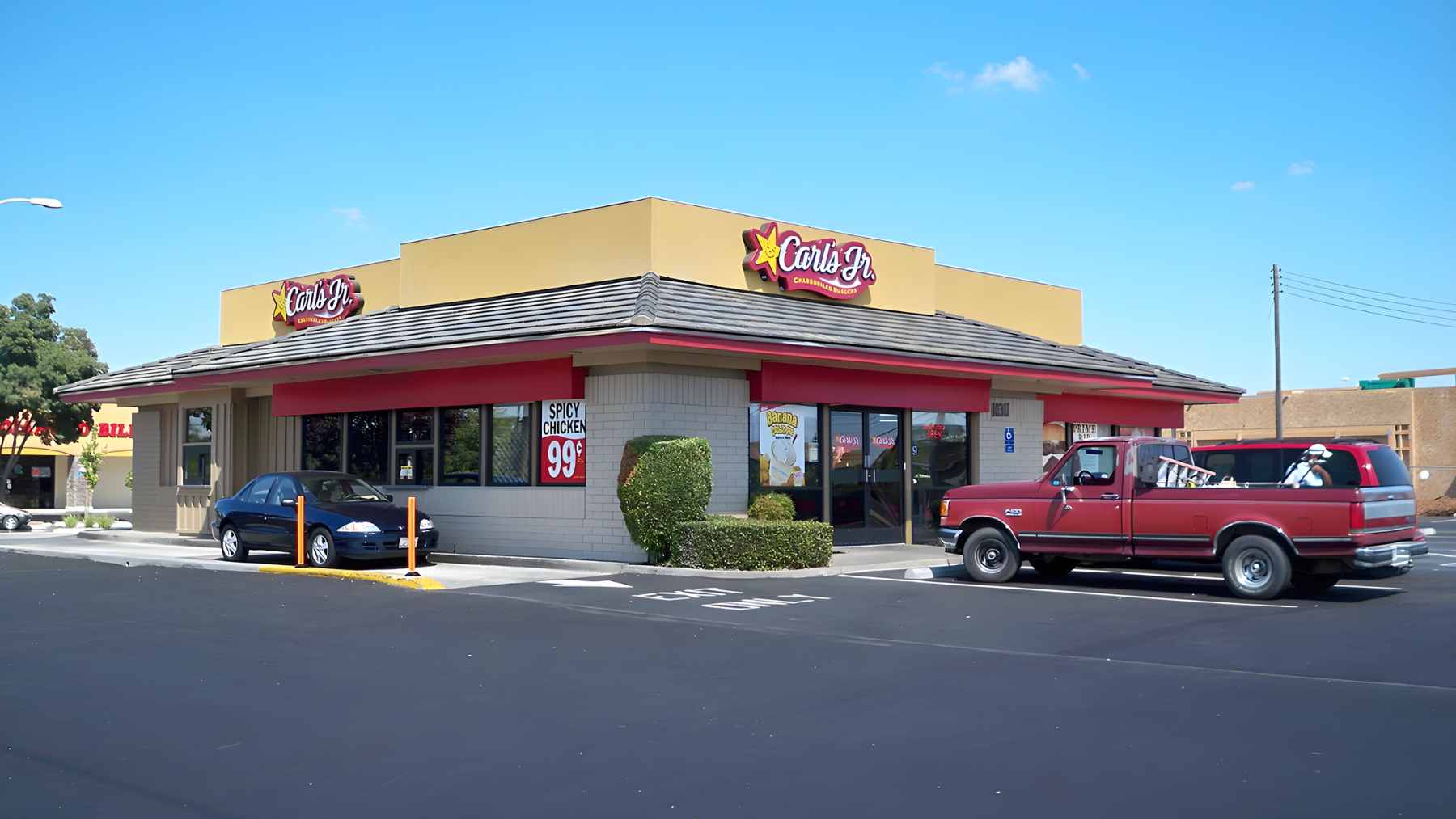 An exterior shot of a Carl's Jr. restaurant building under an overcast sky.