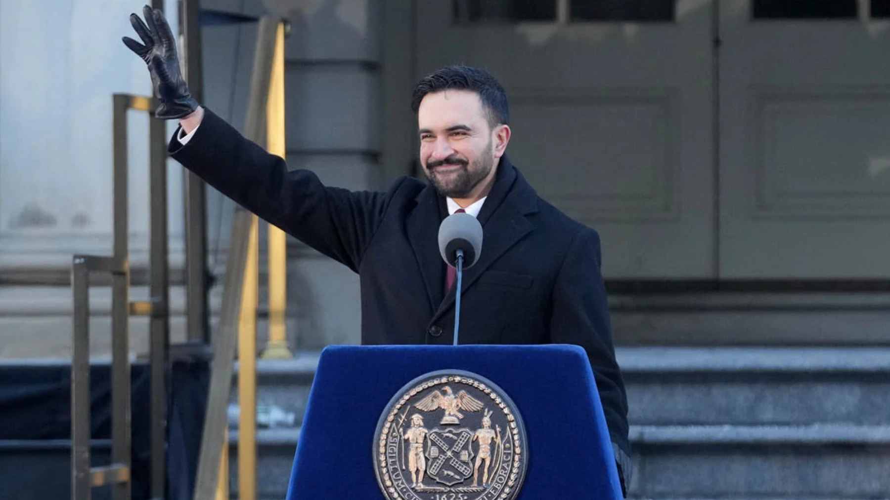 A line of locked, grey Empire Bins taking up a parking spot on a busy New York City street.