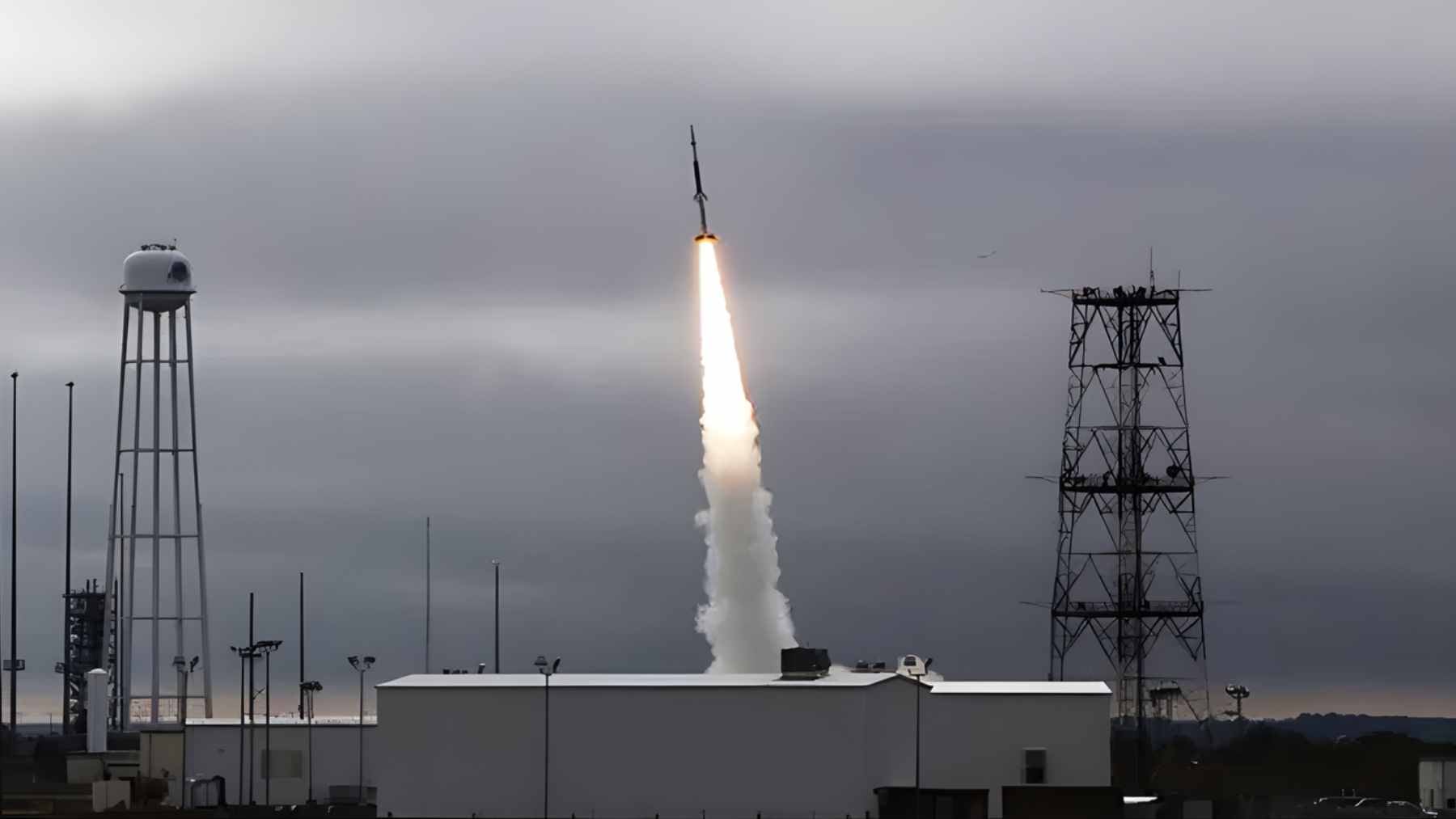 A Rocket Lab HASTE rocket launching from a coastal launchpad, ascending rapidly for a suborbital hypersonic test mission.
