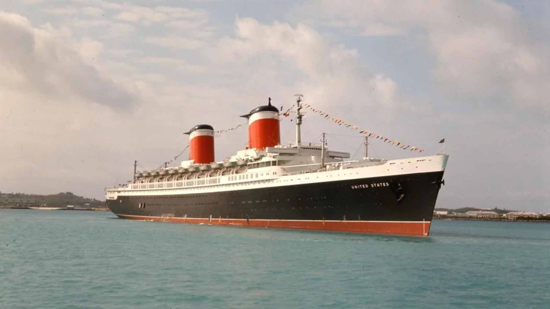 The massive SS United States ocean liner docked and undergoing environmental remediation before being deployed as an artificial reef.