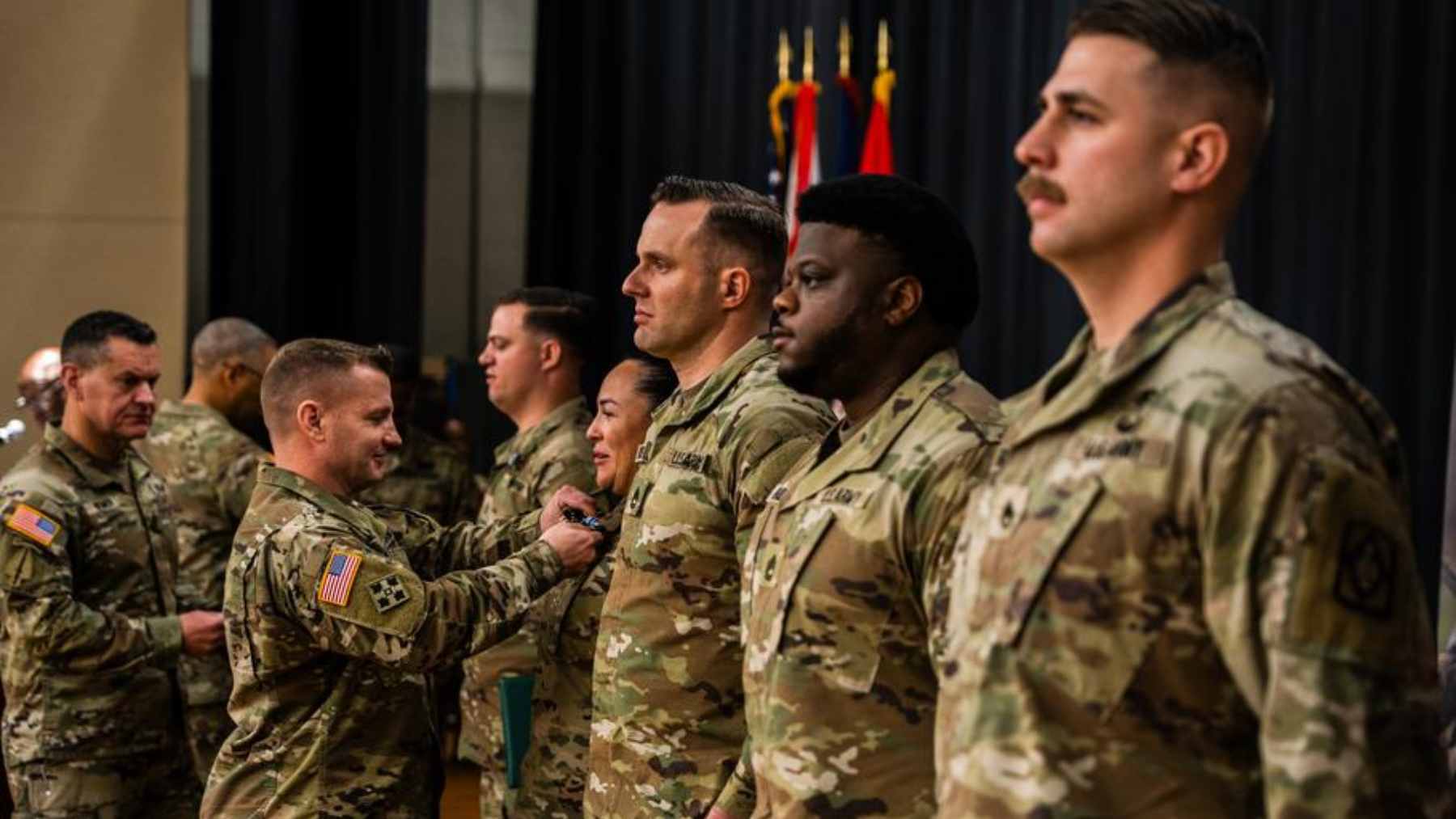 A young American man looking concerned while reading news about automatic Selective Service military registration on his smartphone.