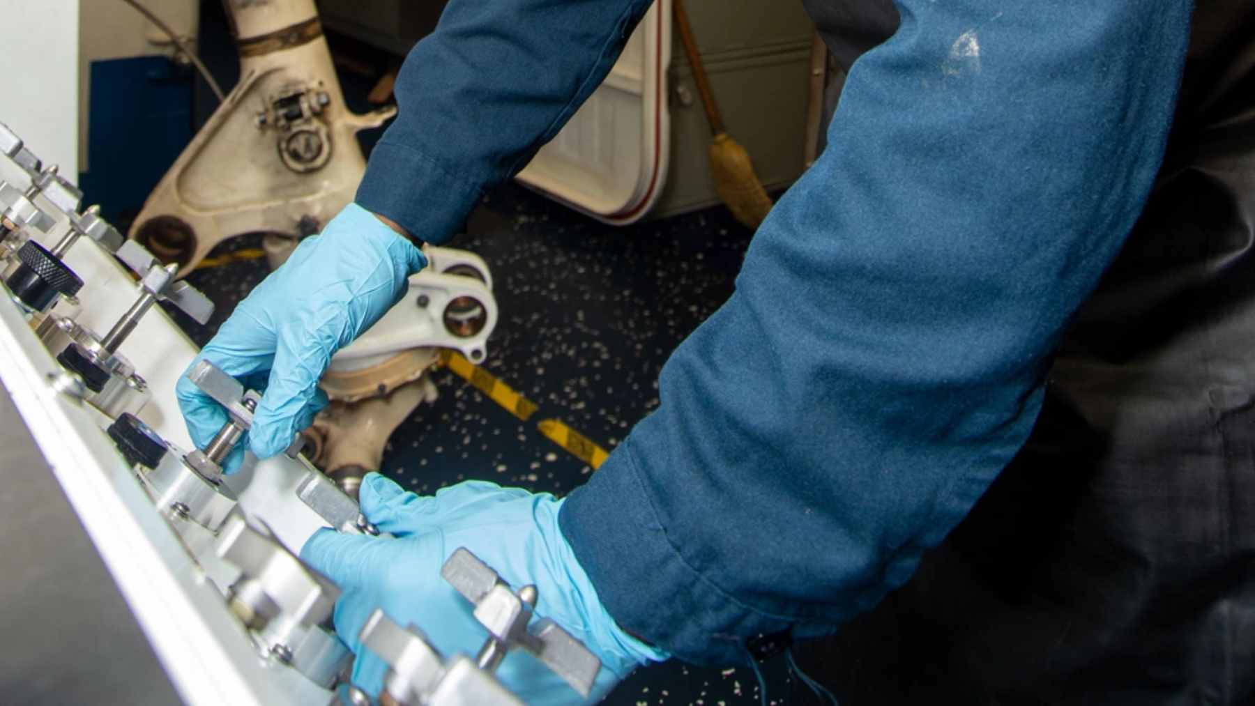 A U.S. military mechanic analyzing a grounded F-35 fighter jet, constrained by restrictive contractor repair agreements.
