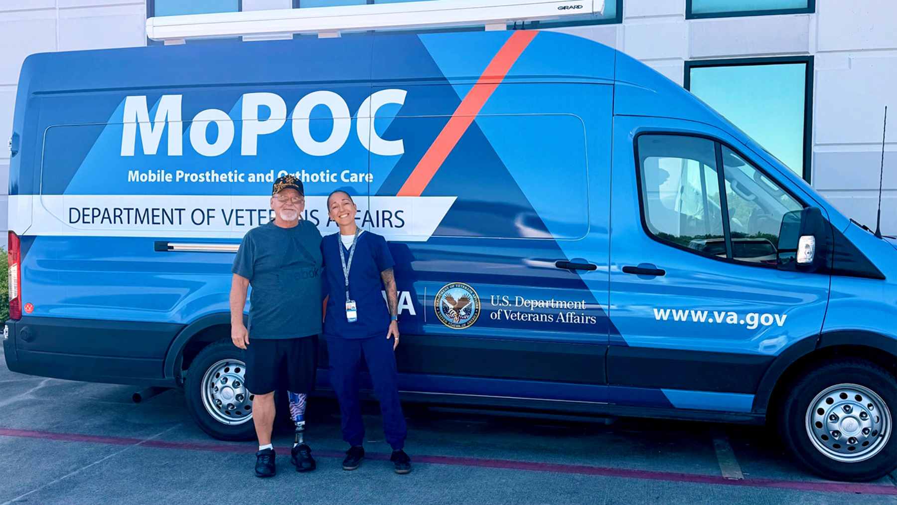 A veteran looking out the window of a shuttle bus while traveling a long distance on a rural highway.