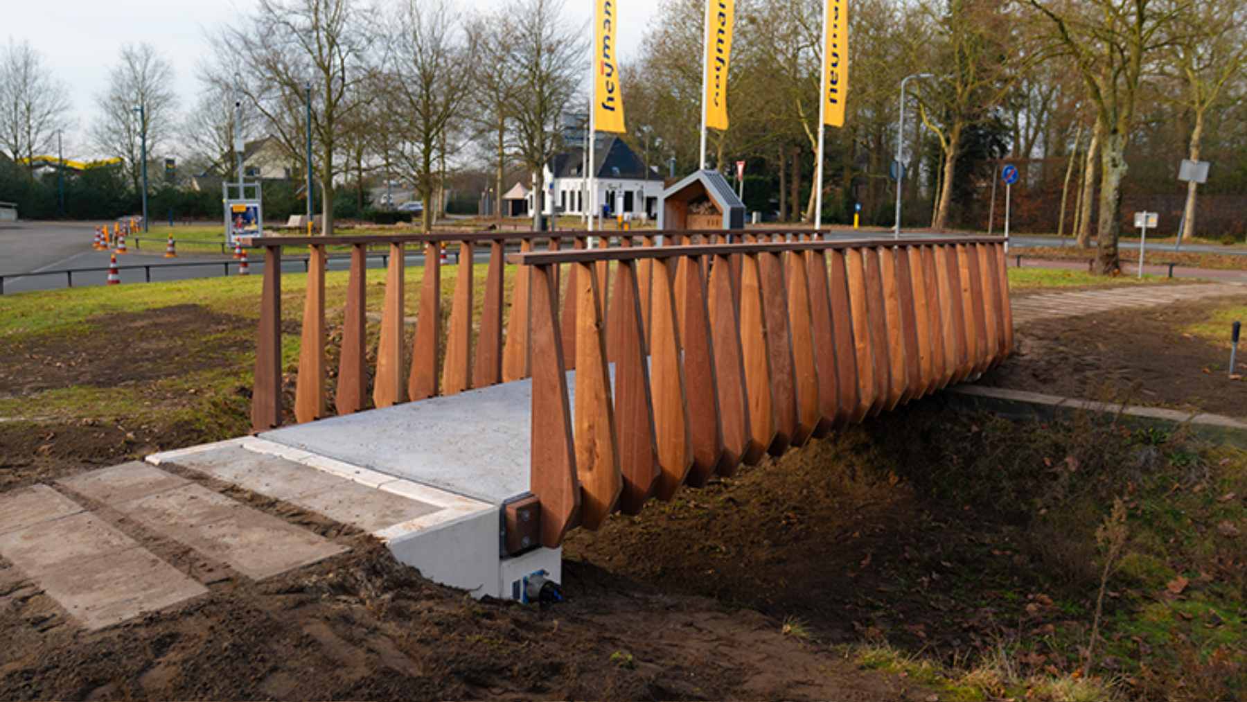 A 7-meter pedestrian footbridge made of carbon-storing concrete over a small waterway in Rosmalen, Netherlands.