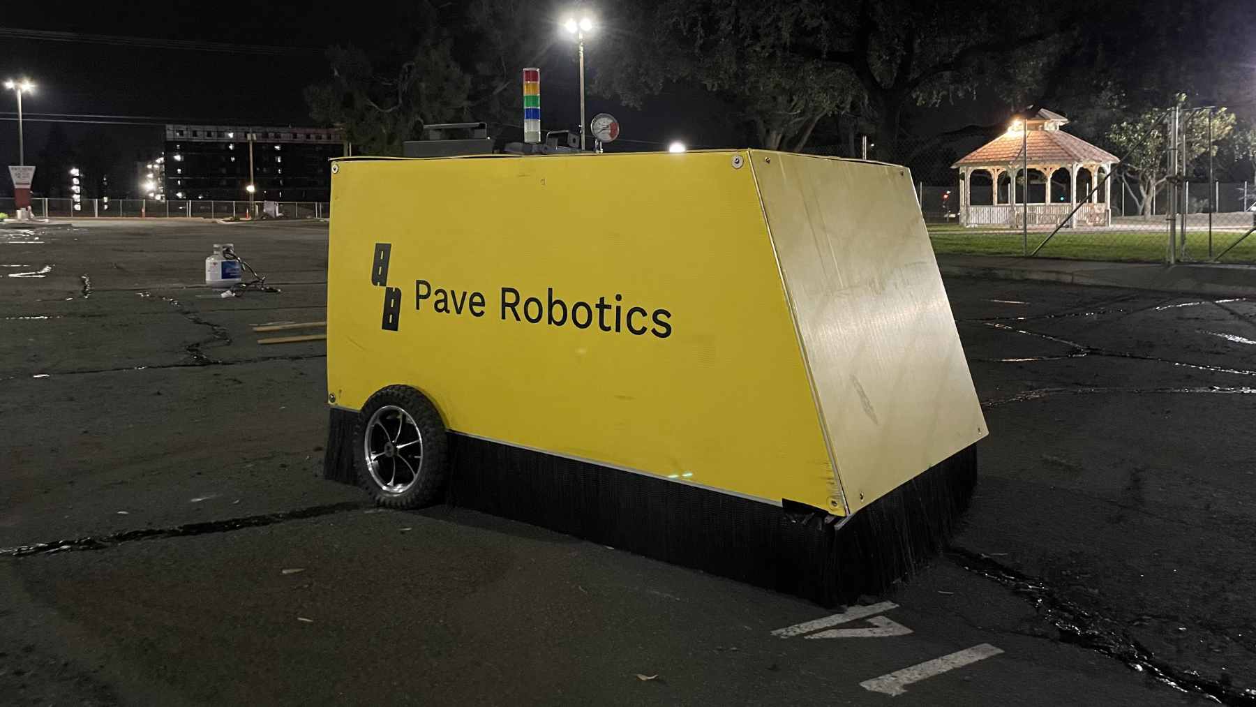 A 3D-controlled robotic asphalt paver resurfacing a major overpass in Bangkok to improve water drainage and road quality.