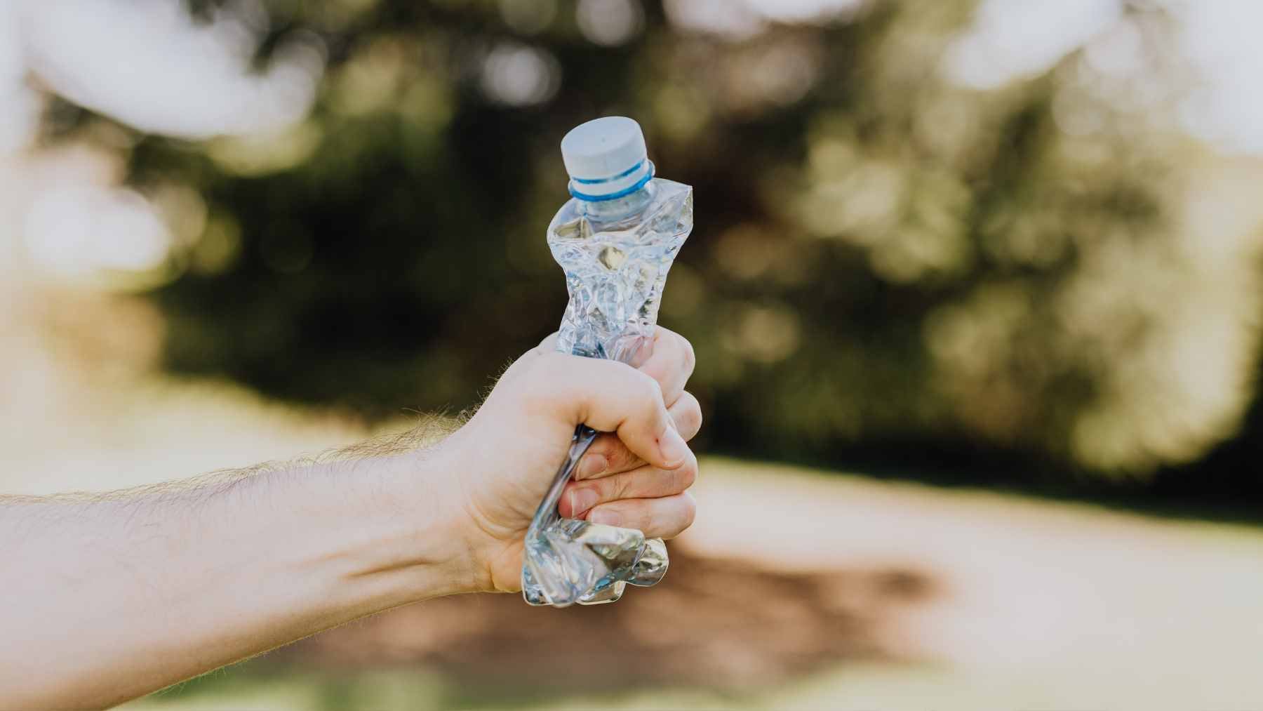 A collection of common plastic product packaging, including food containers and beverage bottles, sorted for potential recycling.