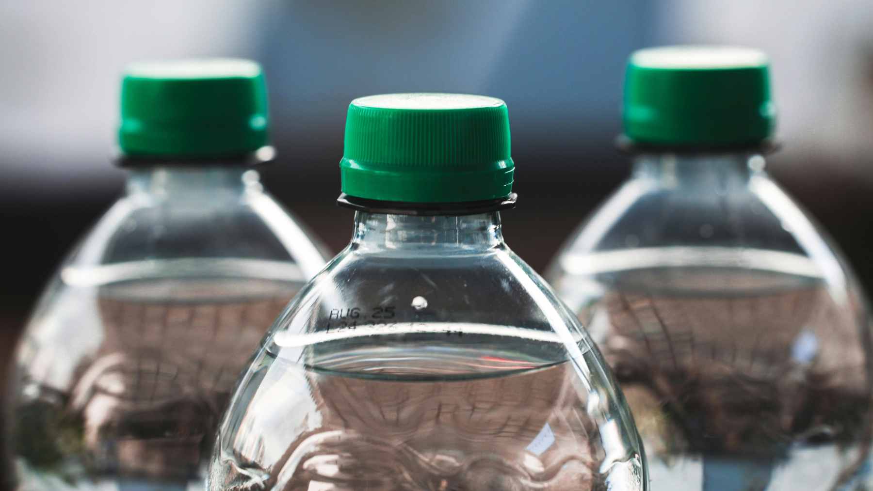 A collection of common plastic product packaging, including food containers and beverage bottles, sorted for potential recycling.