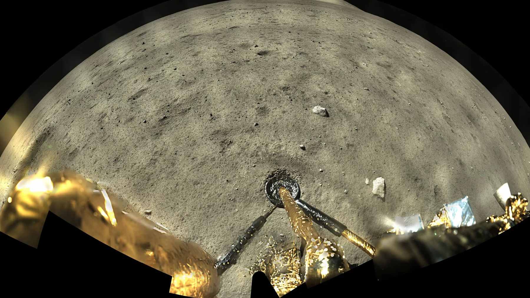 A microscopic image showing translucent, crystalline structures of the rare lunar minerals Magnesiochangesite-(Y) and Changesite-(Ce) found in Chang'e-5 soil samples.