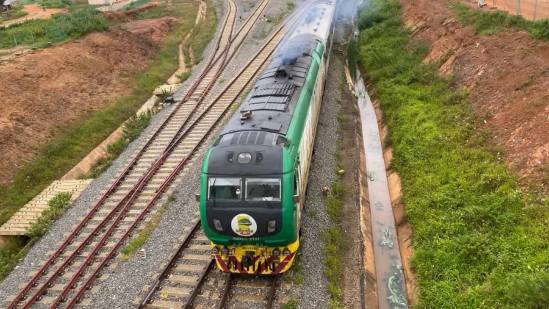 A modern passenger train arriving at a newly constructed standard-gauge railway station in Nigeria.