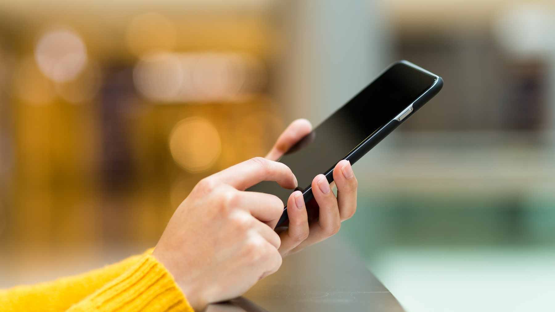 A smartphone screen displaying a "Storage Space Running Out" notification next to icons for Google Photos and WhatsApp.