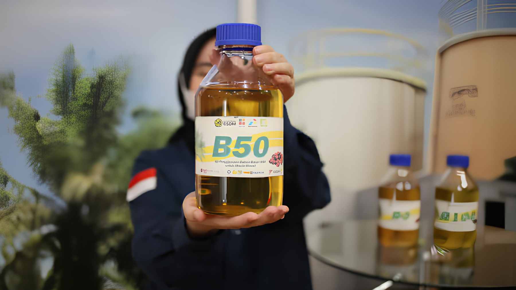 A close-up of a fuel pump dispensing the new B50 biodiesel, a 50% palm oil mix, into a commercial vehicle in Indonesia.