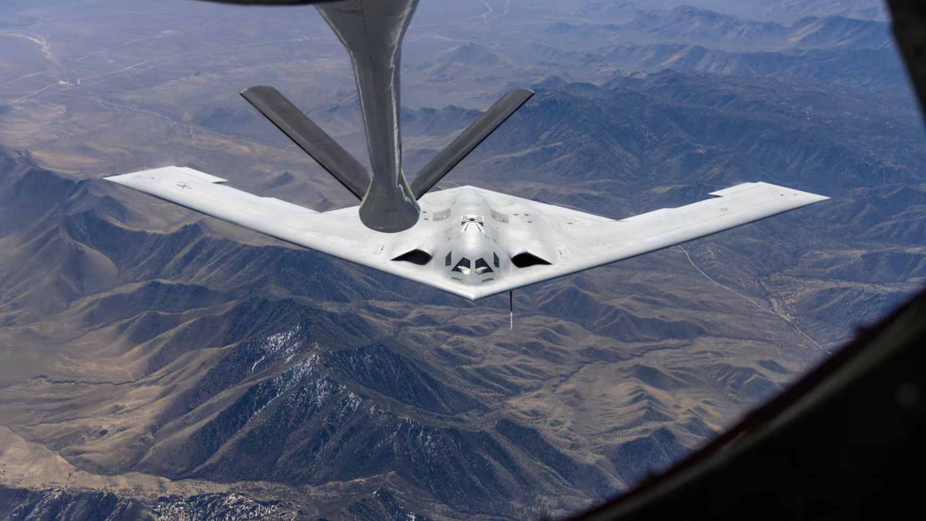 The B-21 Raider stealth bomber conducting a mid-air refueling test with a KC-135 Stratotanker.