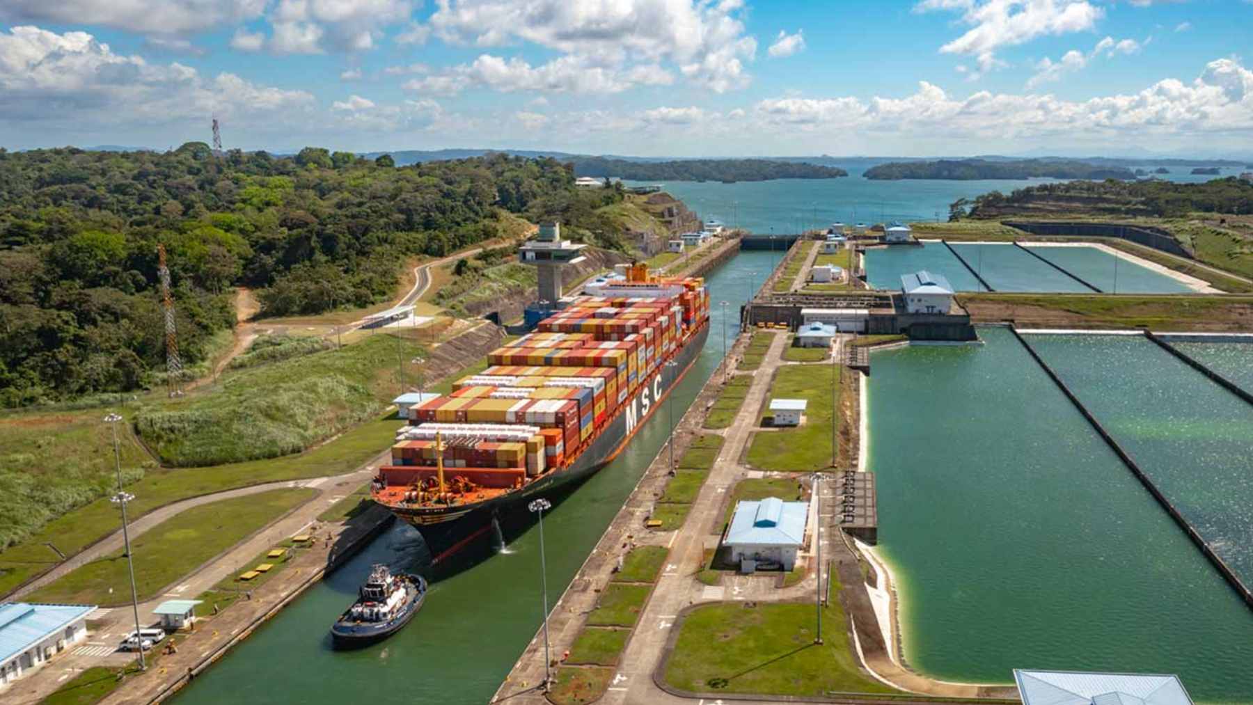 A massive cargo ship navigating through the locks of the Panama Canal.