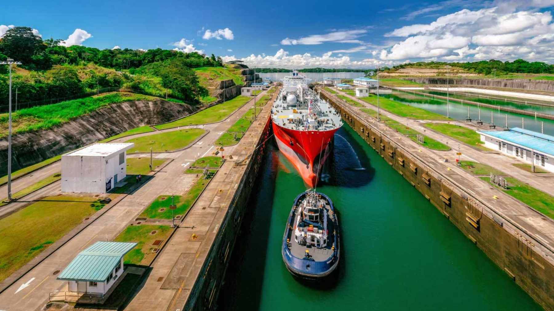 A massive cargo ship navigating through the locks of the Panama Canal.