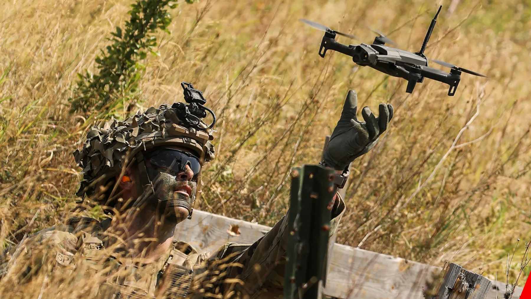 A military technician at Eglin Air Force Base preparing a small tactical drone for a counter-UAS training exercise.