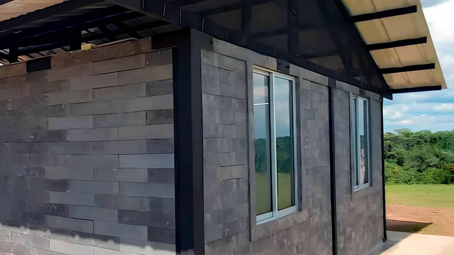 A colorful house in Colombia built entirely from interlocking recycled plastic bricks developed by Conceptos Plásticos.