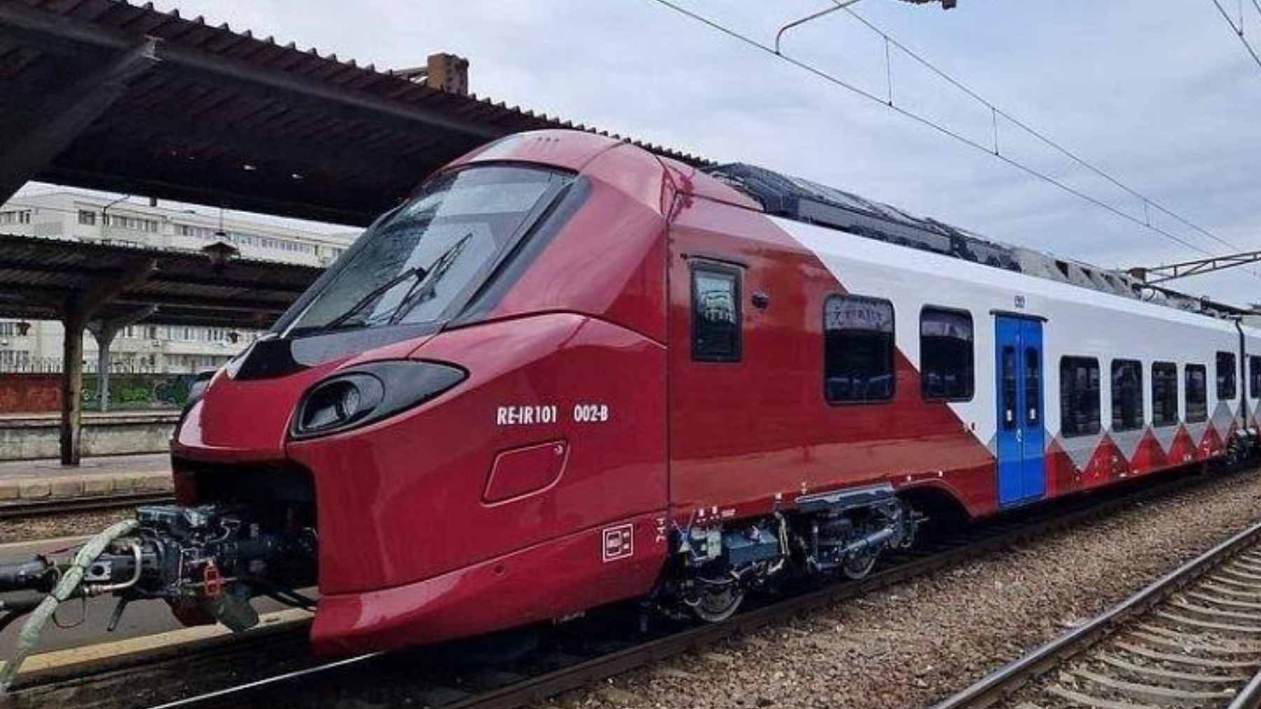 A new Alstom Coradia electric multiple unit train operating at low speed near Radna rail station in Romania.