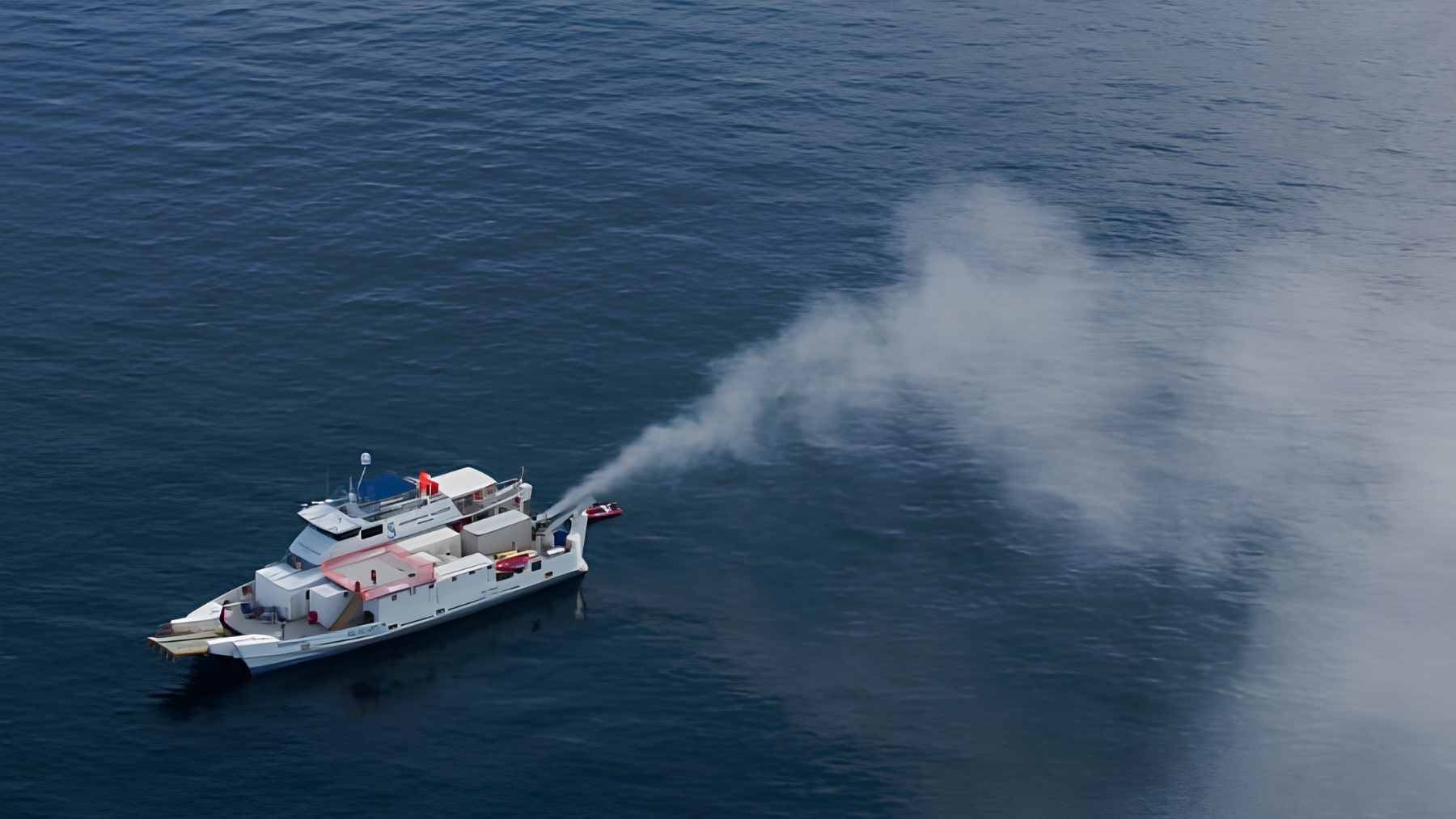 A conceptual illustration of specialized ships spraying fine seawater mist into the atmosphere to brighten marine clouds.