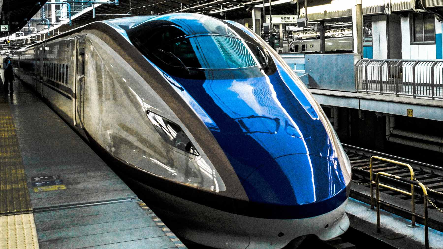 A conceptual rendering of a high-speed bullet train traveling through a futuristic undersea tunnel.