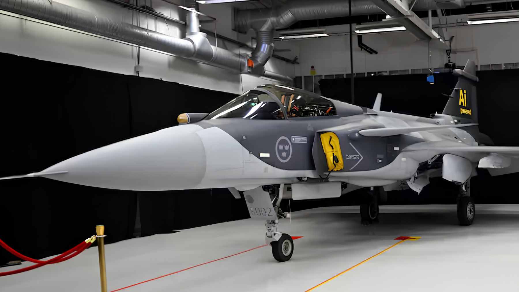 A Swedish Air Force JAS 39 Gripen fighter jet performing aerobatics with a visible smoke trail.