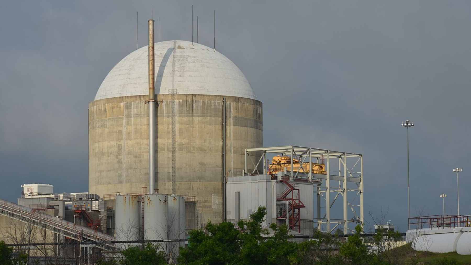 Exterior view of Duke Energy's H.B. Robinson Nuclear Plant in South Carolina, showing the reactor building and energy transmission infrastructure.