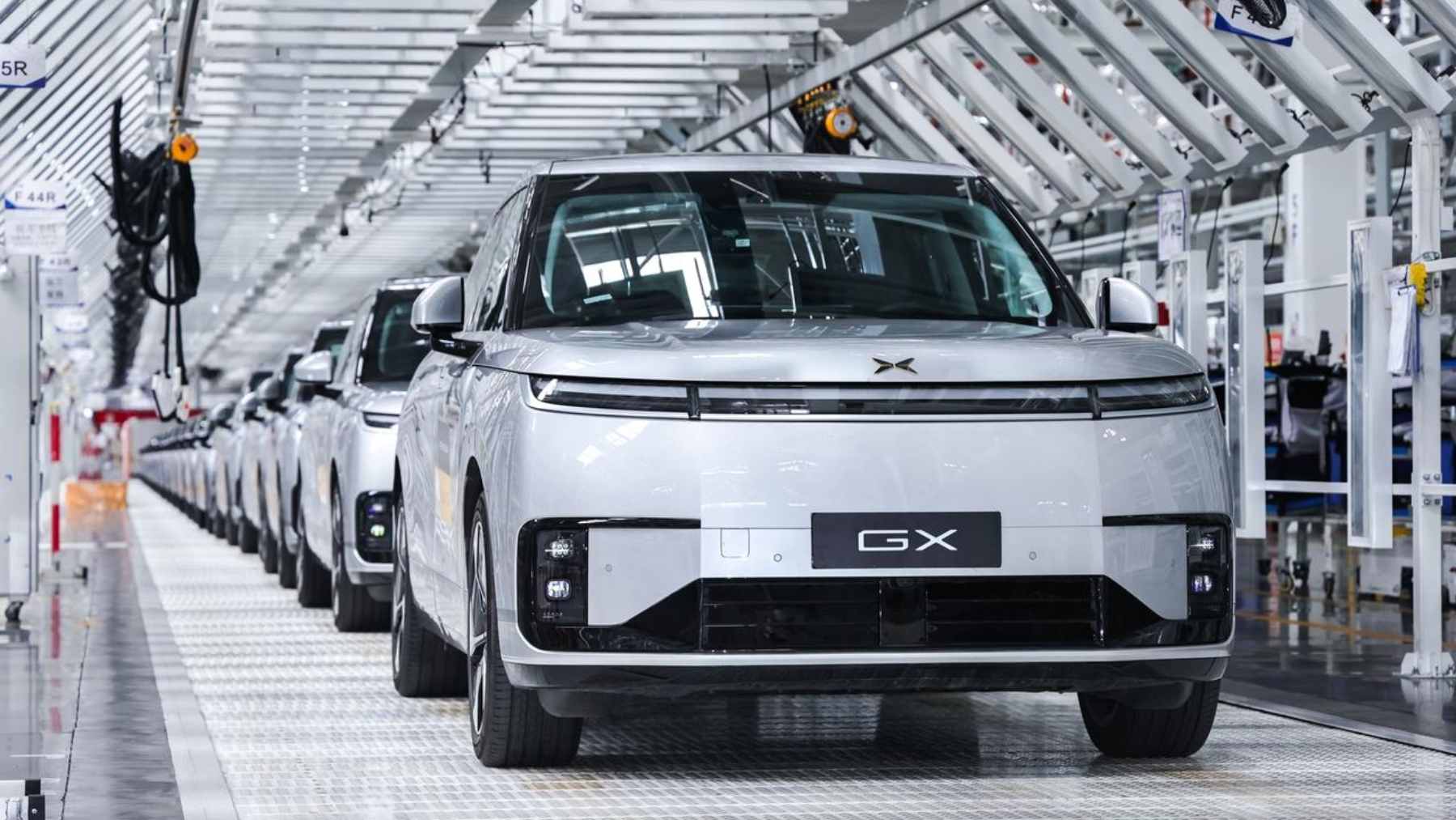 The first mass-produced XPENG L4 robotaxi rolling off the assembly line in Guangzhou, featuring a sensor-heavy pure-vision design.
