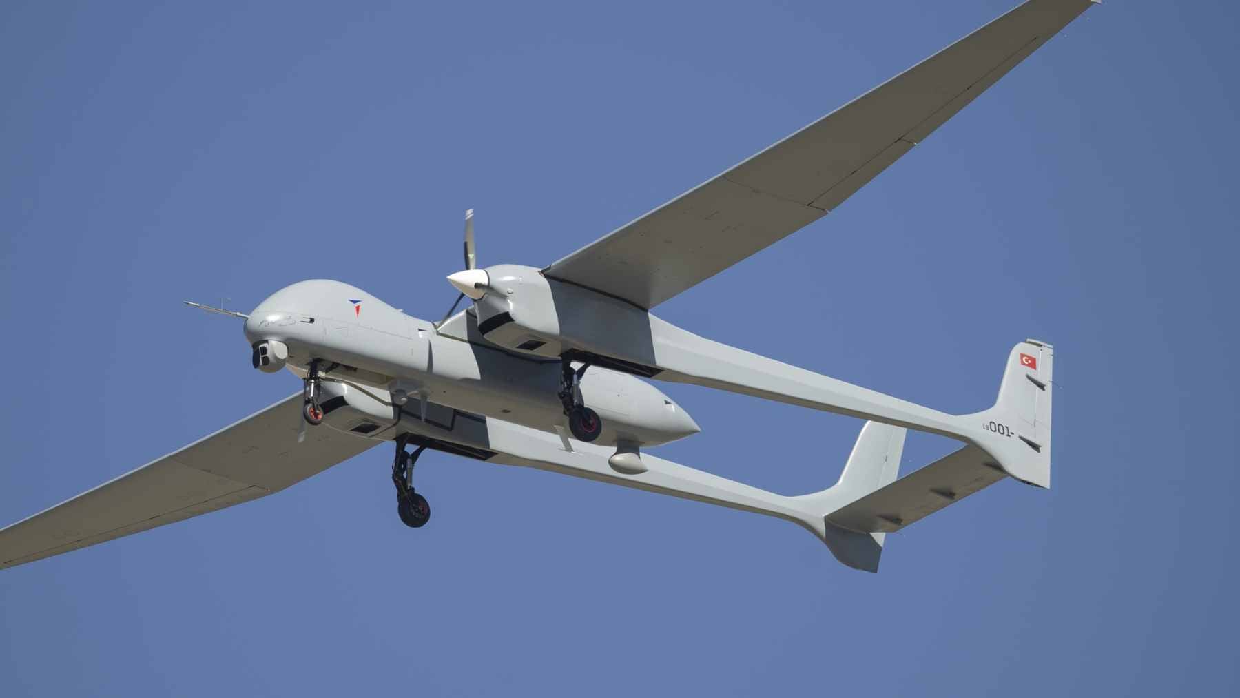 Turkish Aerospace Industries Aksungur UAV carrying two Süper Şimşek jet-powered drones under its wings during a flight test.