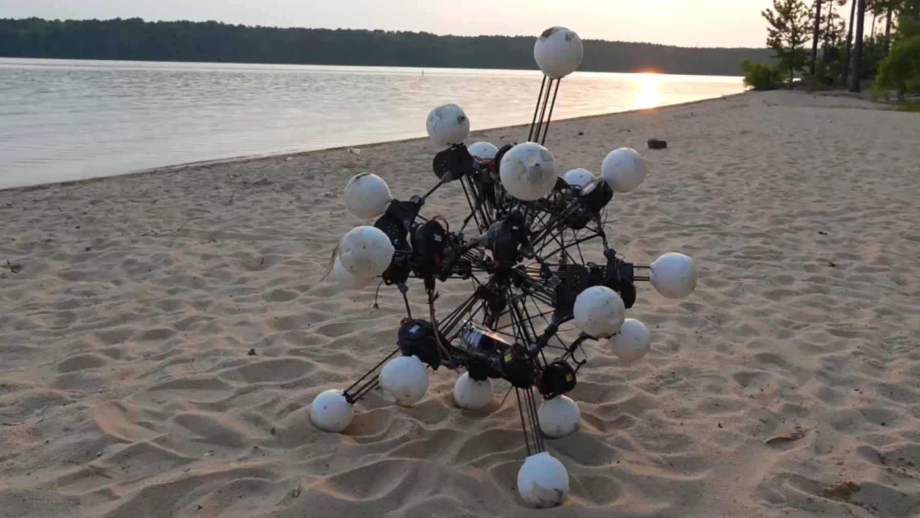 The Argus robot, featuring 20 telescoping legs and integrated depth cameras, navigating over rough outdoor terrain during field tests at Duke University.