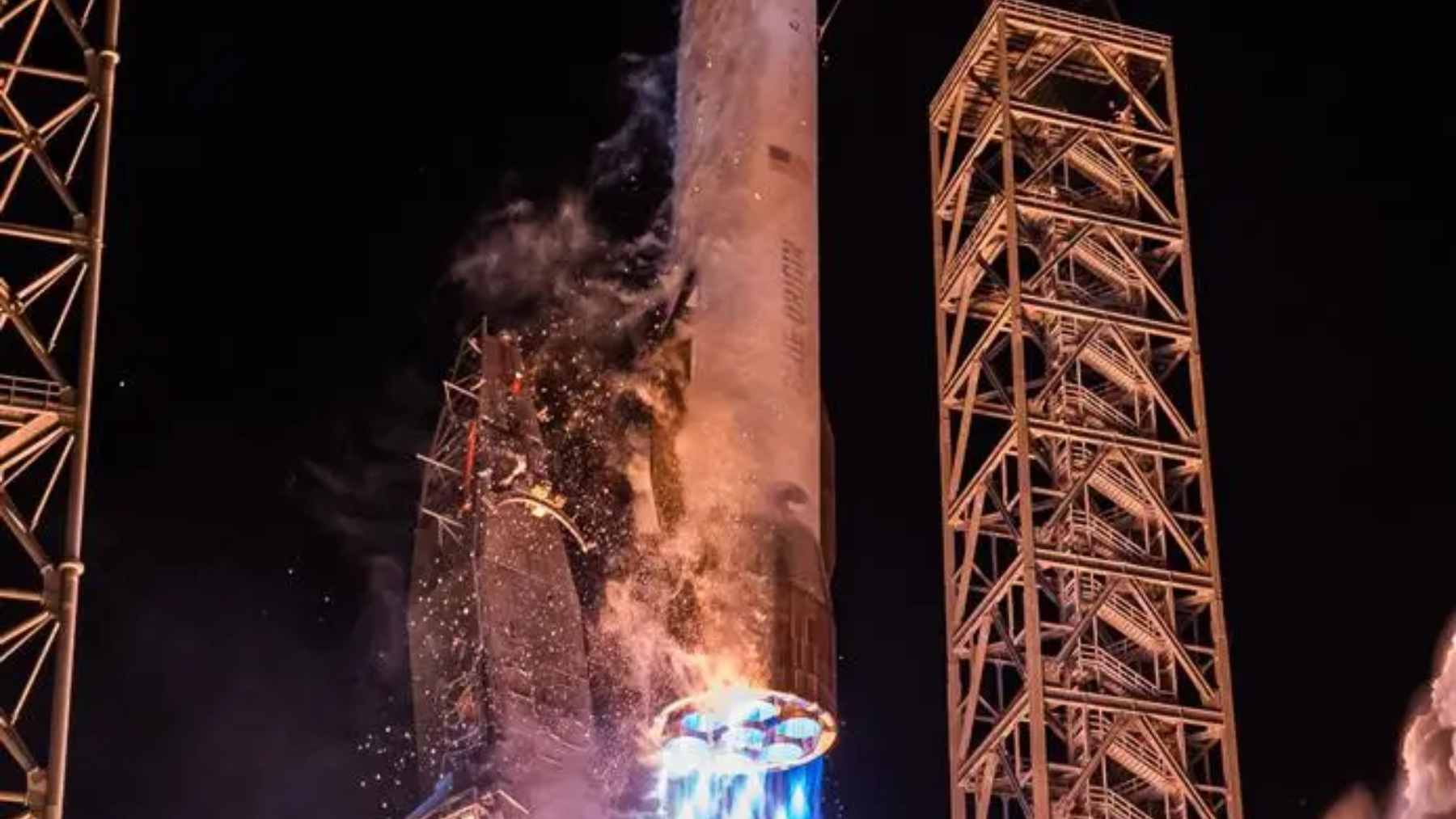 The aftermath of the Blue Origin New Glenn explosion at Launch Complex 36, showing significant damage to the launch pad and gantry structure.