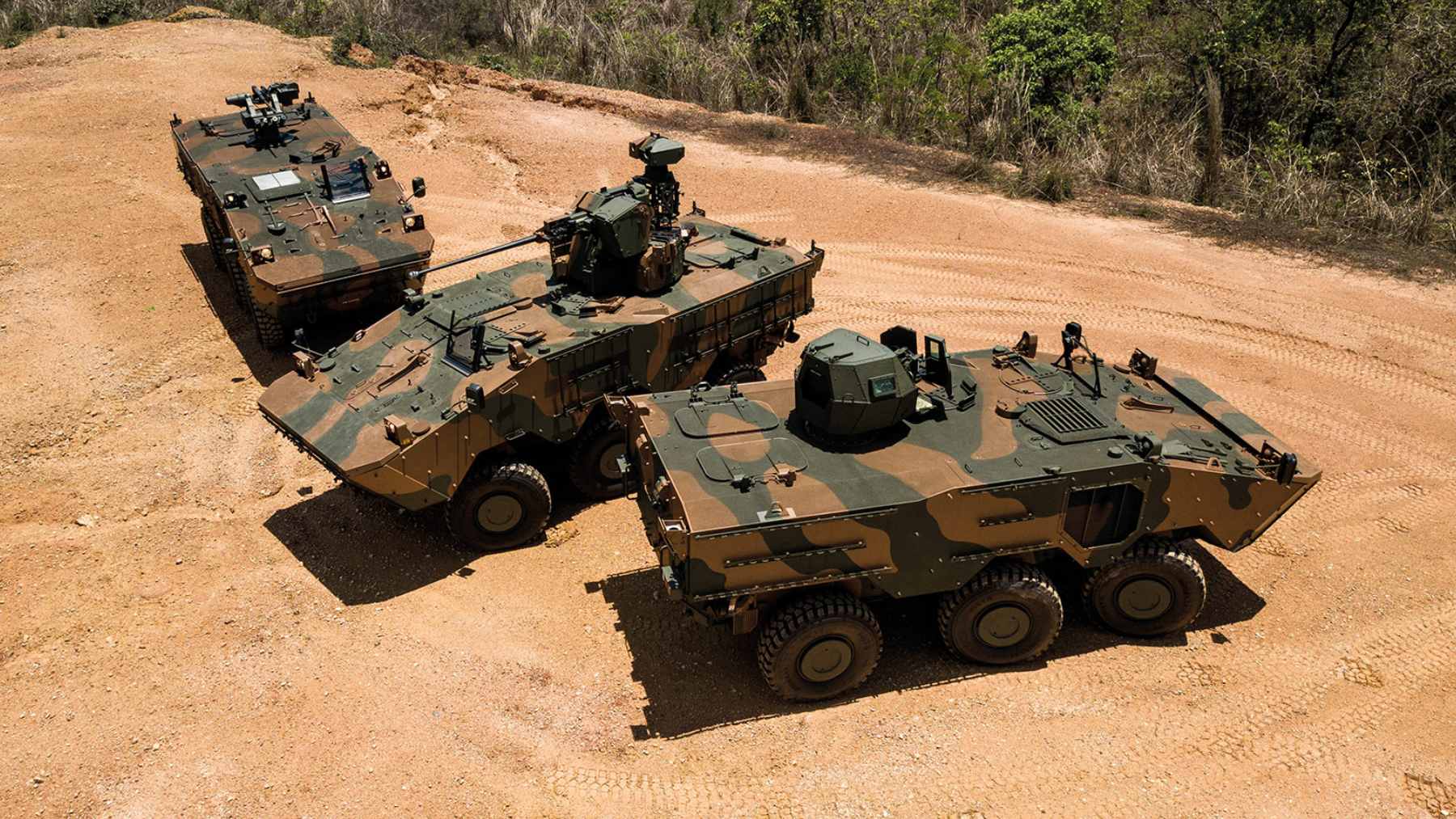 A Brazilian Army Guarani 6x6 amphibious armored troop carrier driving through a flooded area during rescue operations.