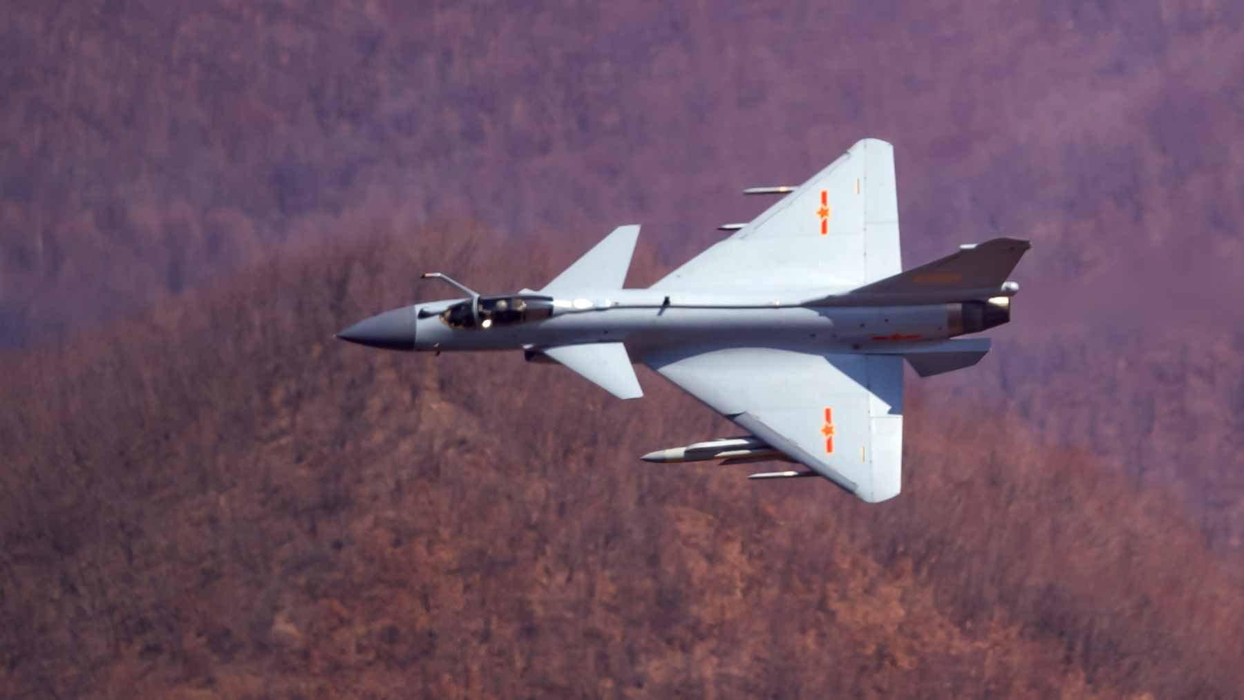 A Chinese Chengdu J-10B fighter jet performing a maneuver during a military exhibition, showcasing its modern avionics and airframe design.