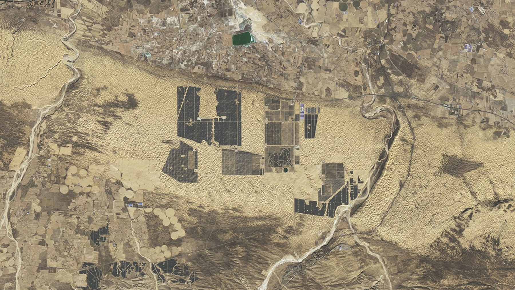 An aerial view of the massive solar panel arrays in China's Kubuqi Desert, forming part of the expansive Solar Great Wall energy project.