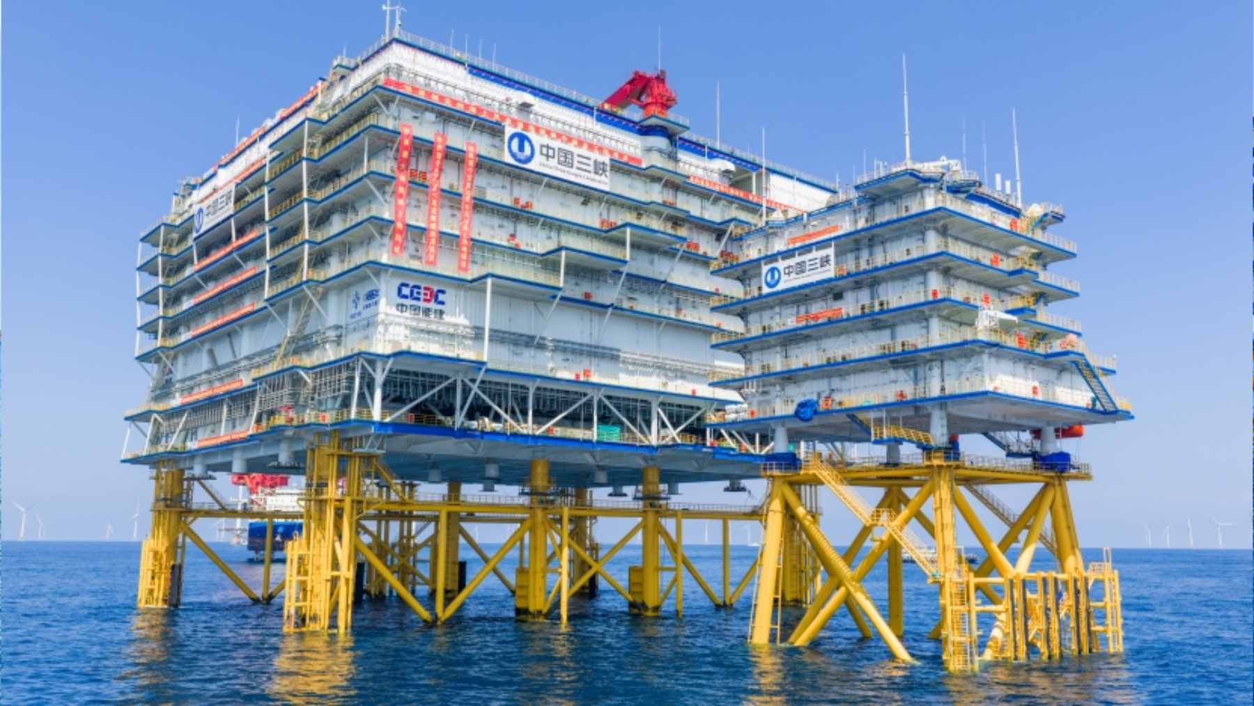 A massive offshore converter station platform being positioned at sea to support large-scale wind farm grid integration.
