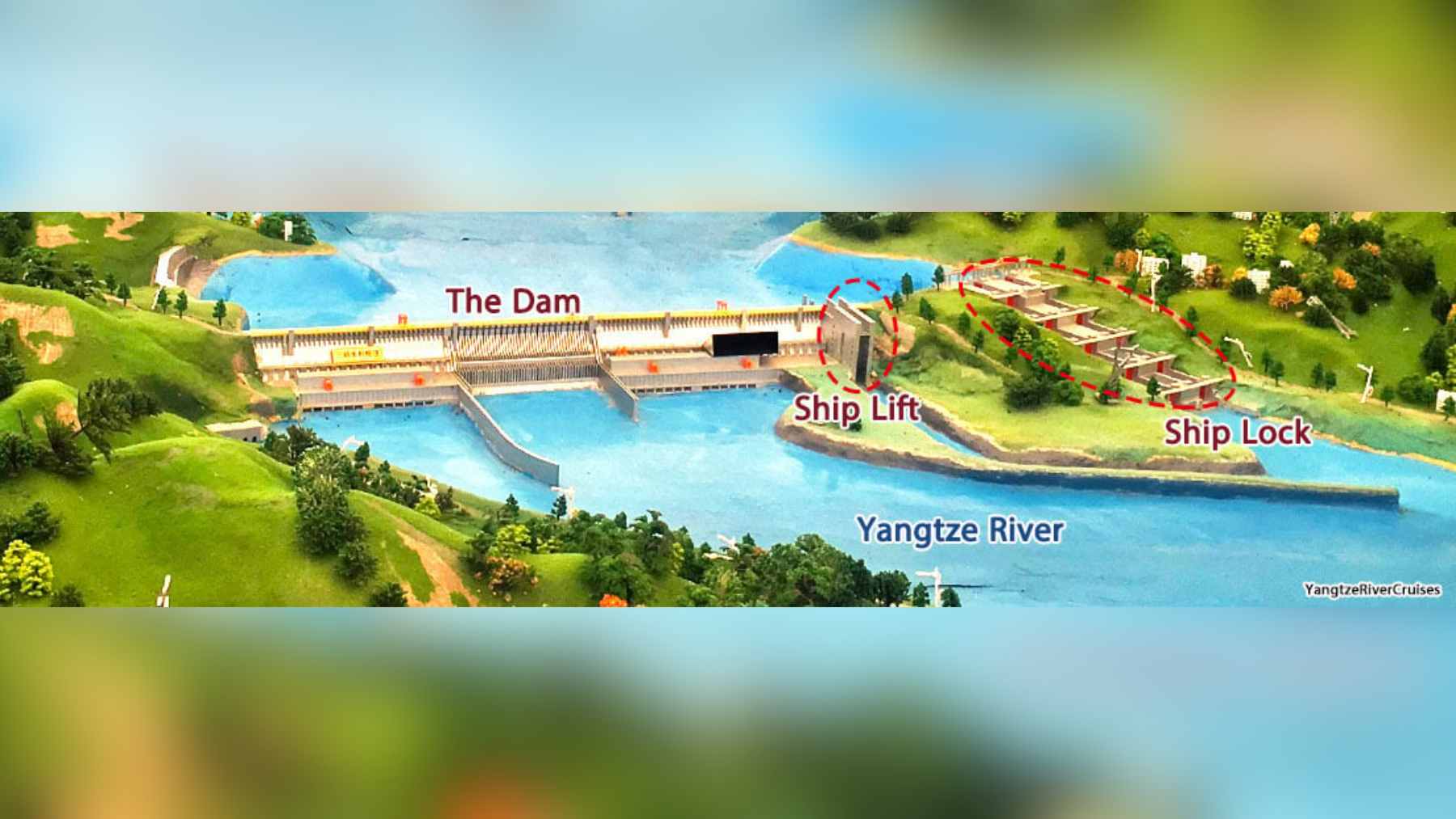 An aerial view of the Three Gorges Dam facility with construction equipment visible for the new five-tier ship lock expansion project.