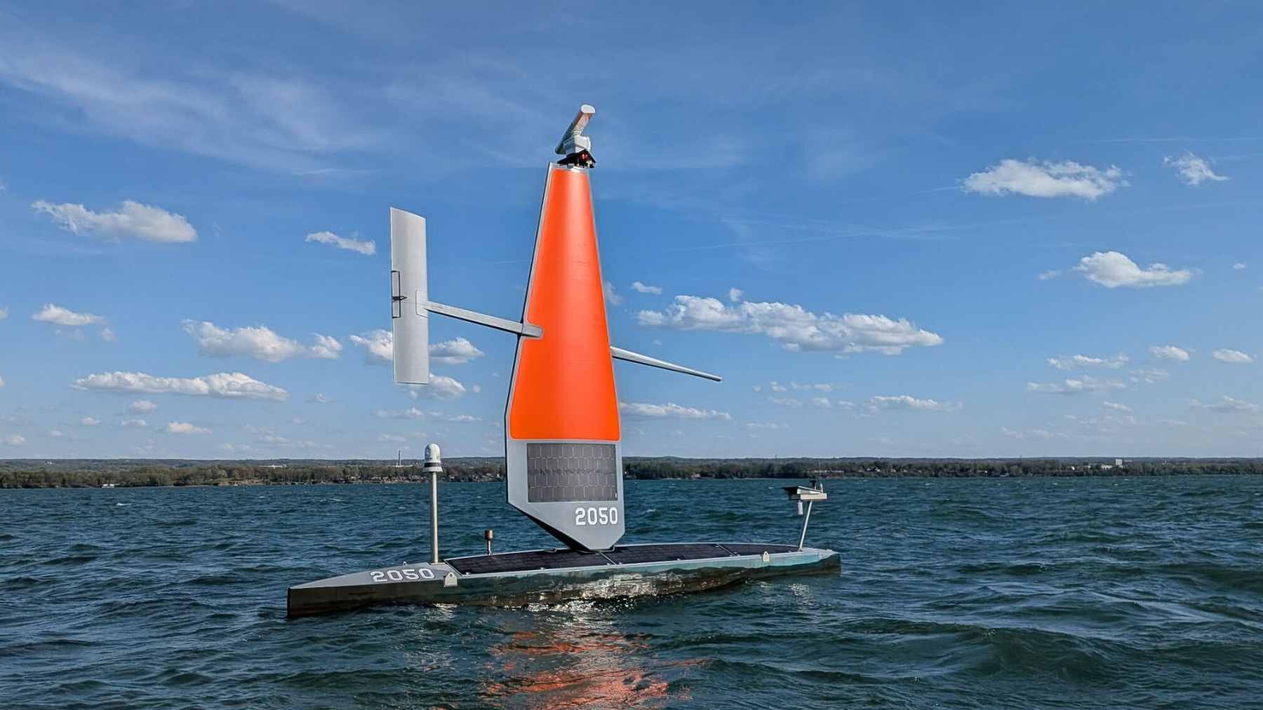 A 33-foot Saildrone Voyager autonomous vessel, seen in image, patrolling the open waters of the Great Lakes for border security.