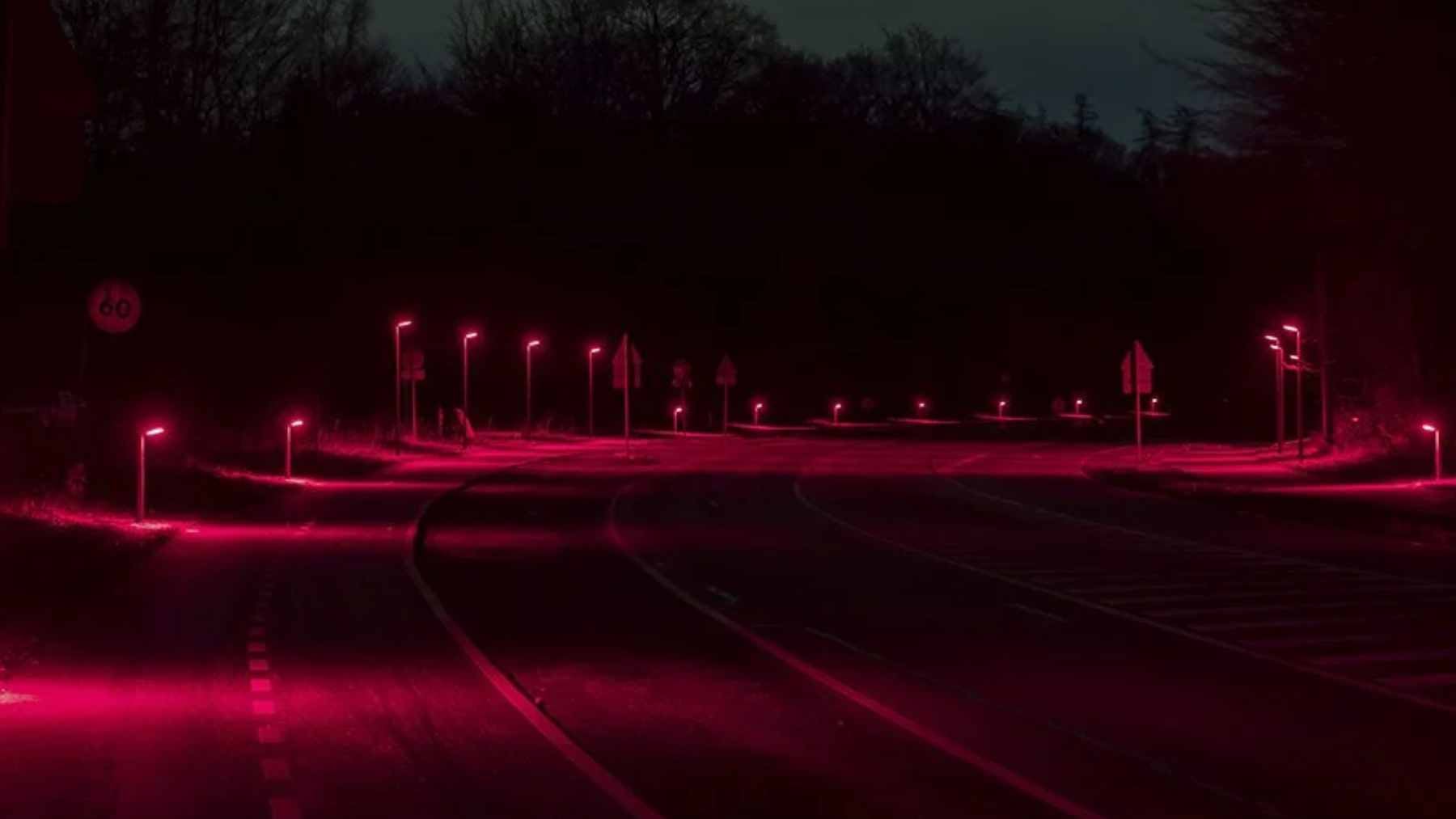 A suburban road in Gladsaxe, Denmark, illuminated by low-profile red LED bollards designed to minimize light pollution for local bat species.