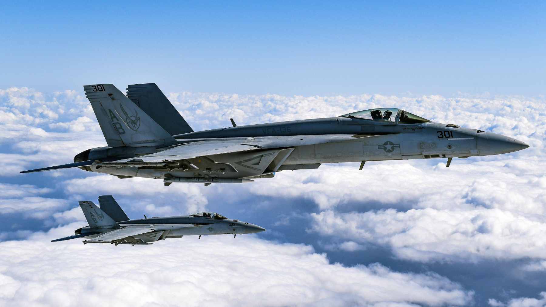 Two Finnish Air Force F/A-18 Hornets escorting a Finnair Embraer 190 carrying the national ice hockey team back to Helsinki.