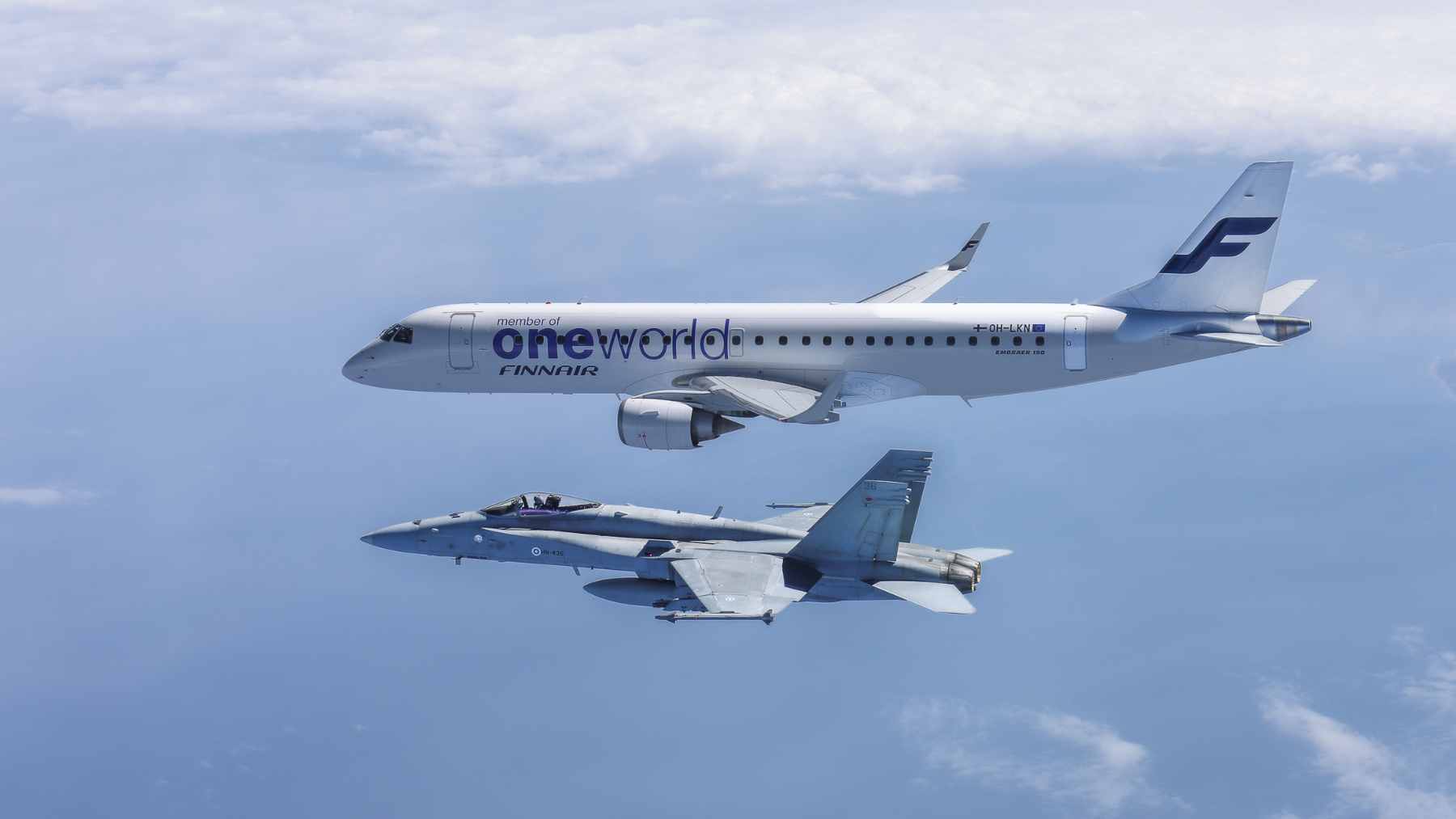 Finnish F/A-18 Hornets escort an Embraer carrying ice champions, and the flight turns sports glory into an airpower image 1 Two Finnish Air Force F/A-18 Hornets escorting a Finnair Embraer 190 carrying the national ice hockey team back to Helsinki.