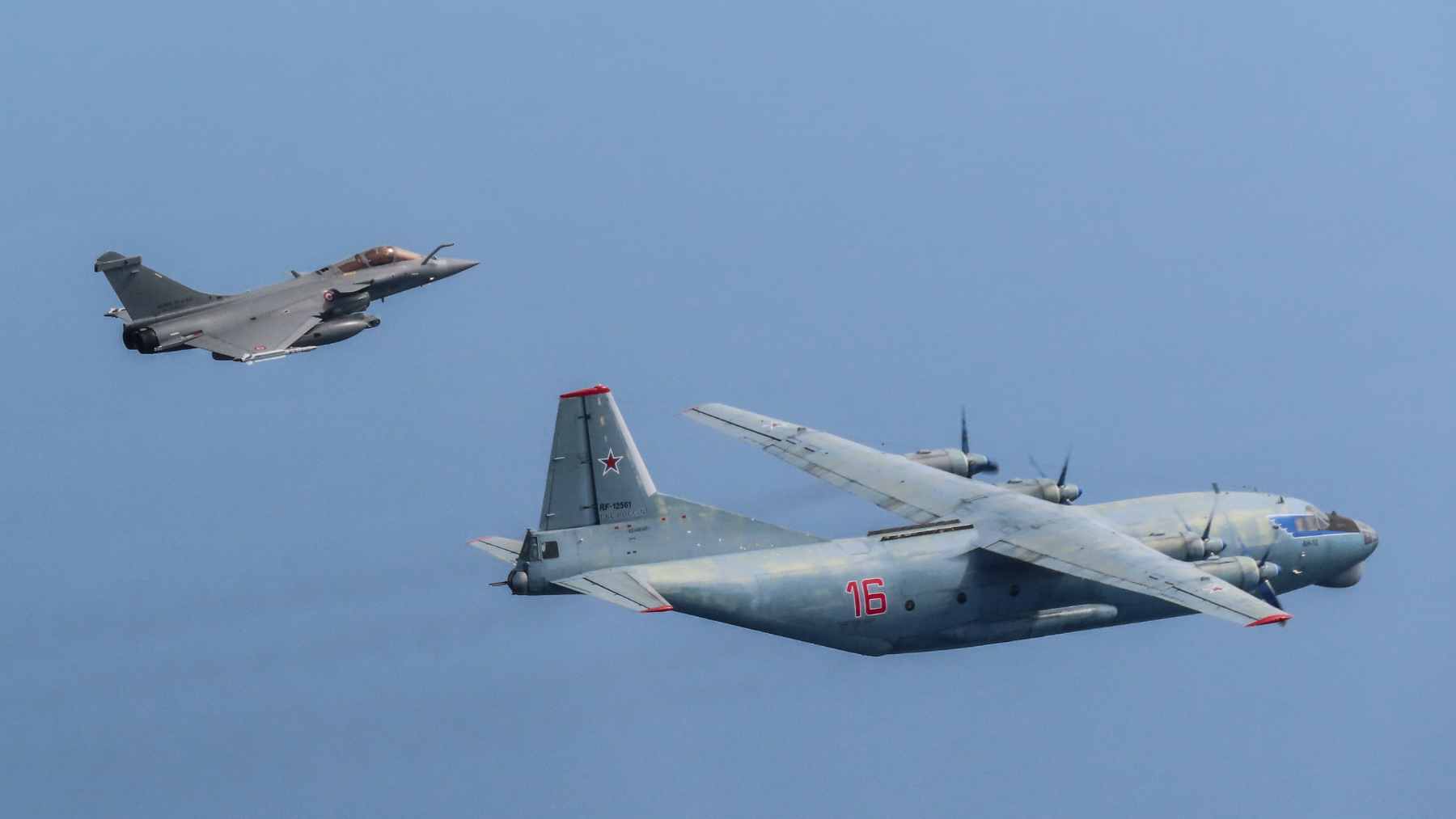 French Rafale and Swedish Gripen fighter jets flying in formation during a NATO Baltic Air Policing interception mission.