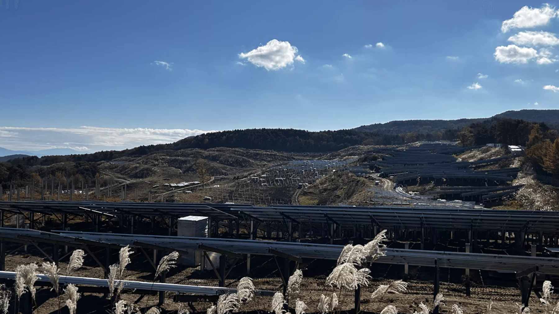 A wide view of the Mount Sendatsu solar plant, showing the layout of panels that are causing unexpected light reflection in nearby neighborhoods.