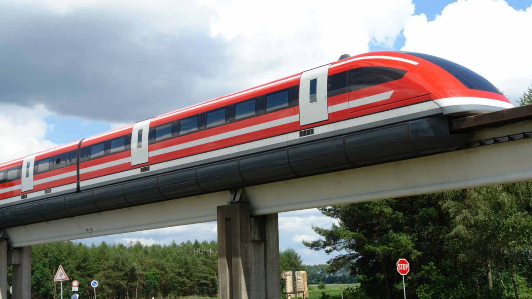 A sleek Transrapid maglev train cruising on the elevated guideway in Shanghai, utilizing German-engineered technology.
