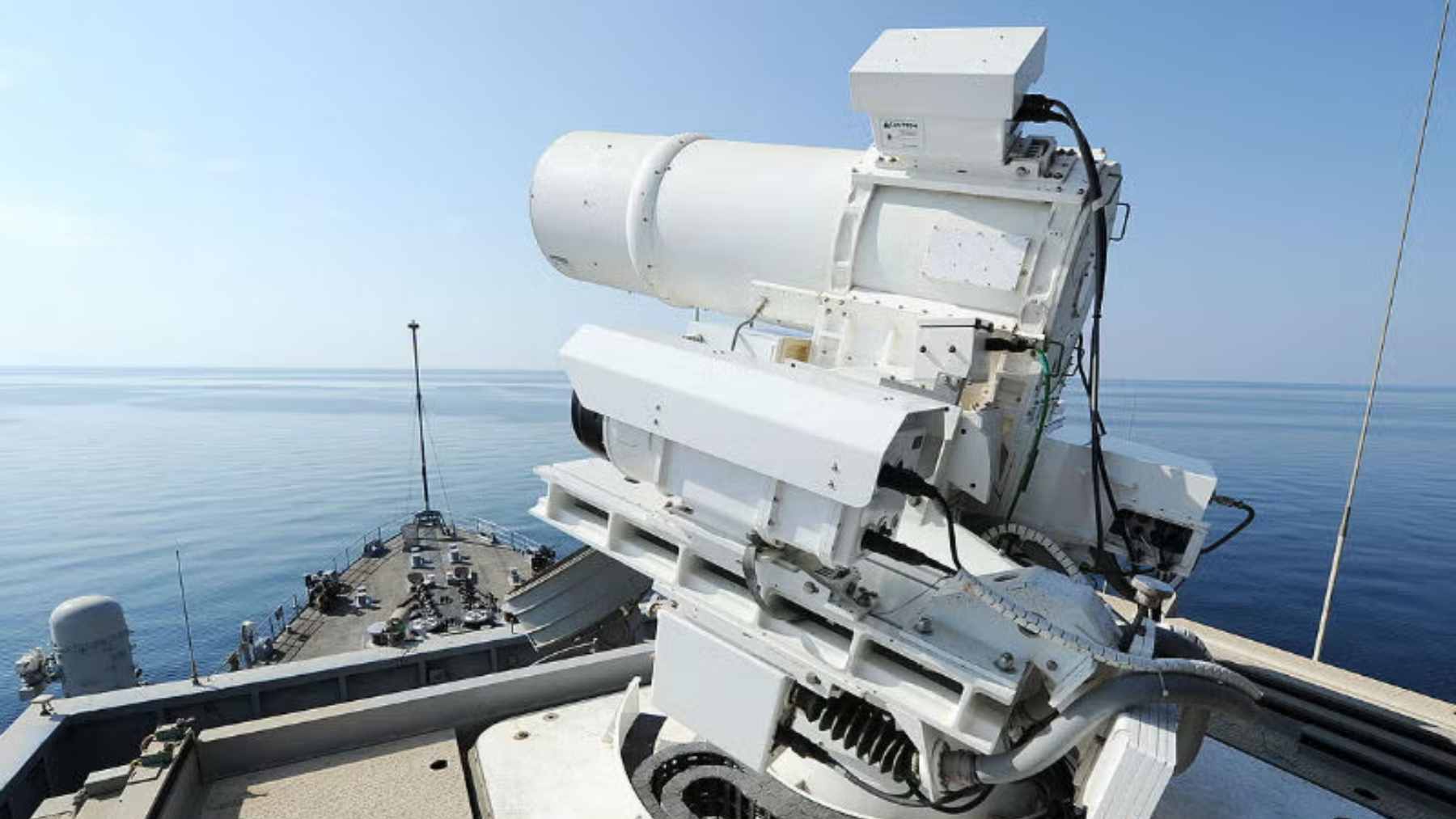 A containerized high-energy laser weapon system mounted on the deck of a U.S. Navy warship, prepared for anti-drone testing.