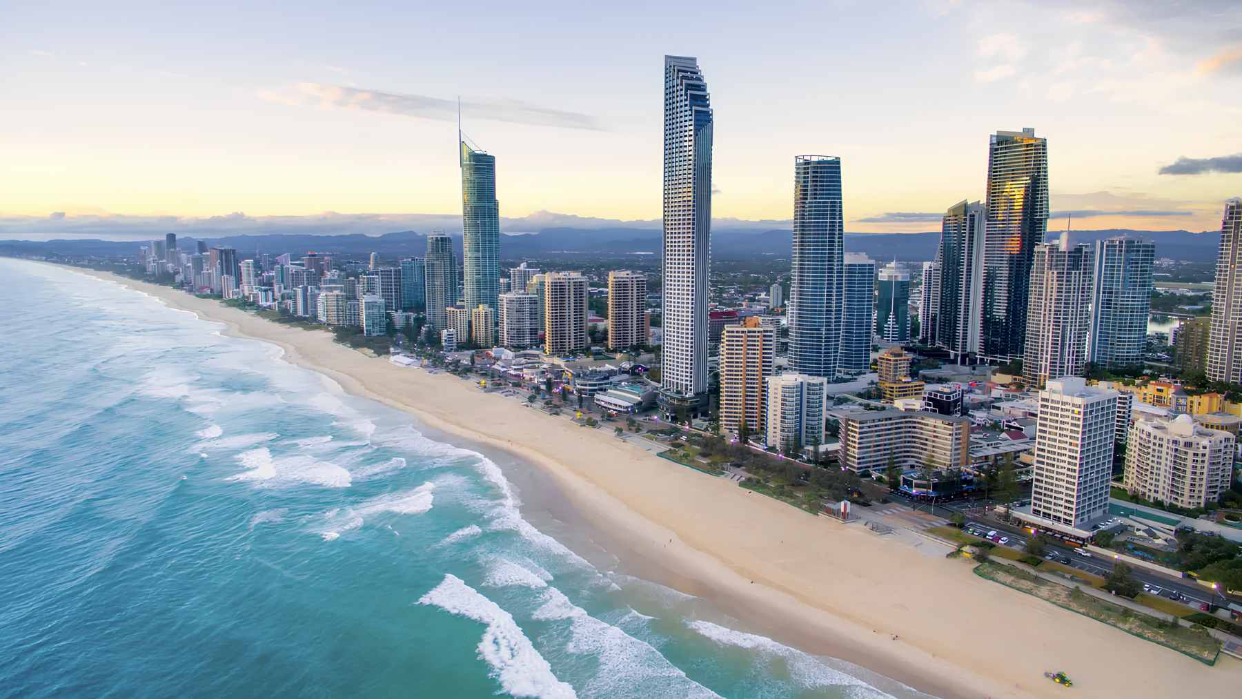 The Gold Coast Sand Bypass jetty extending into the Pacific Ocean, where submerged pumps move sand to prevent erosion and maintain navigation channels.