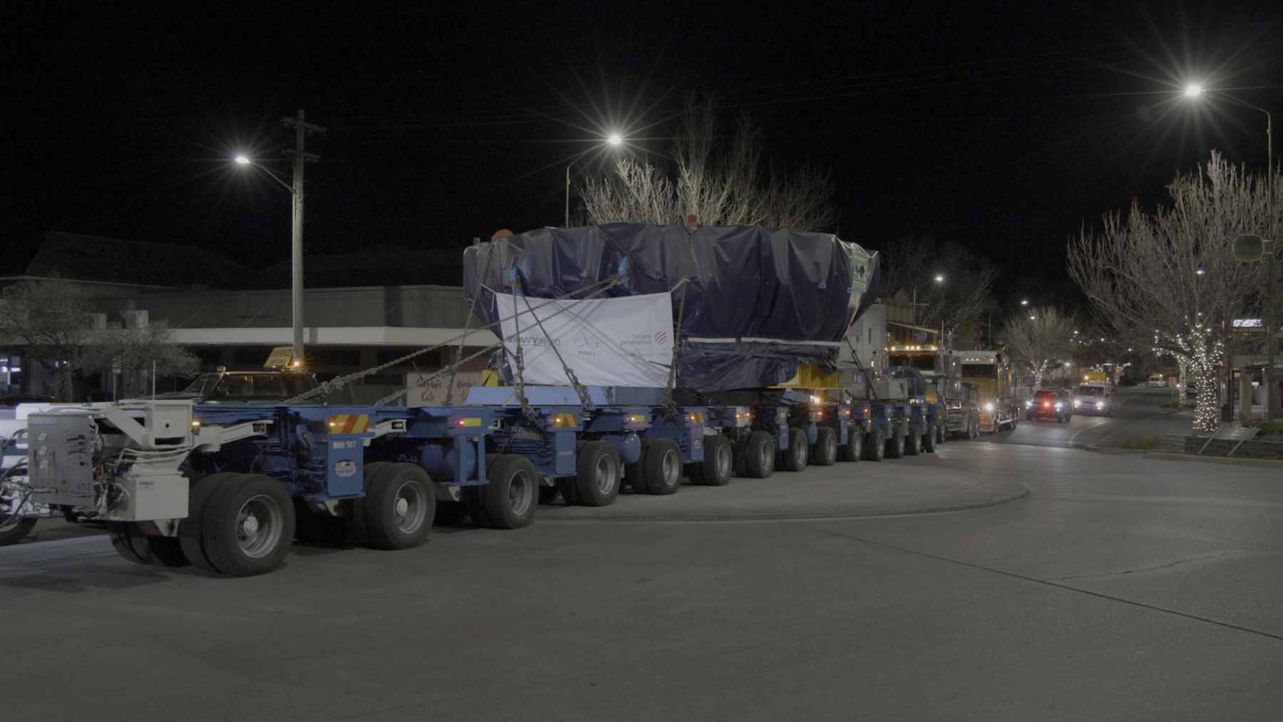 The 151-ton center cutterhead for TBM Monica being transported through Cooma on a specialized 152-wheel heavy-load trailer.