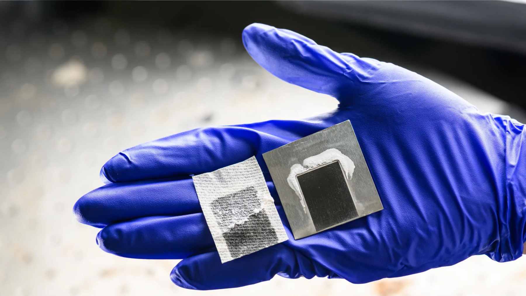 A close-up of a laser-etched black metal solar panel used for seawater desalination and mineral extraction.