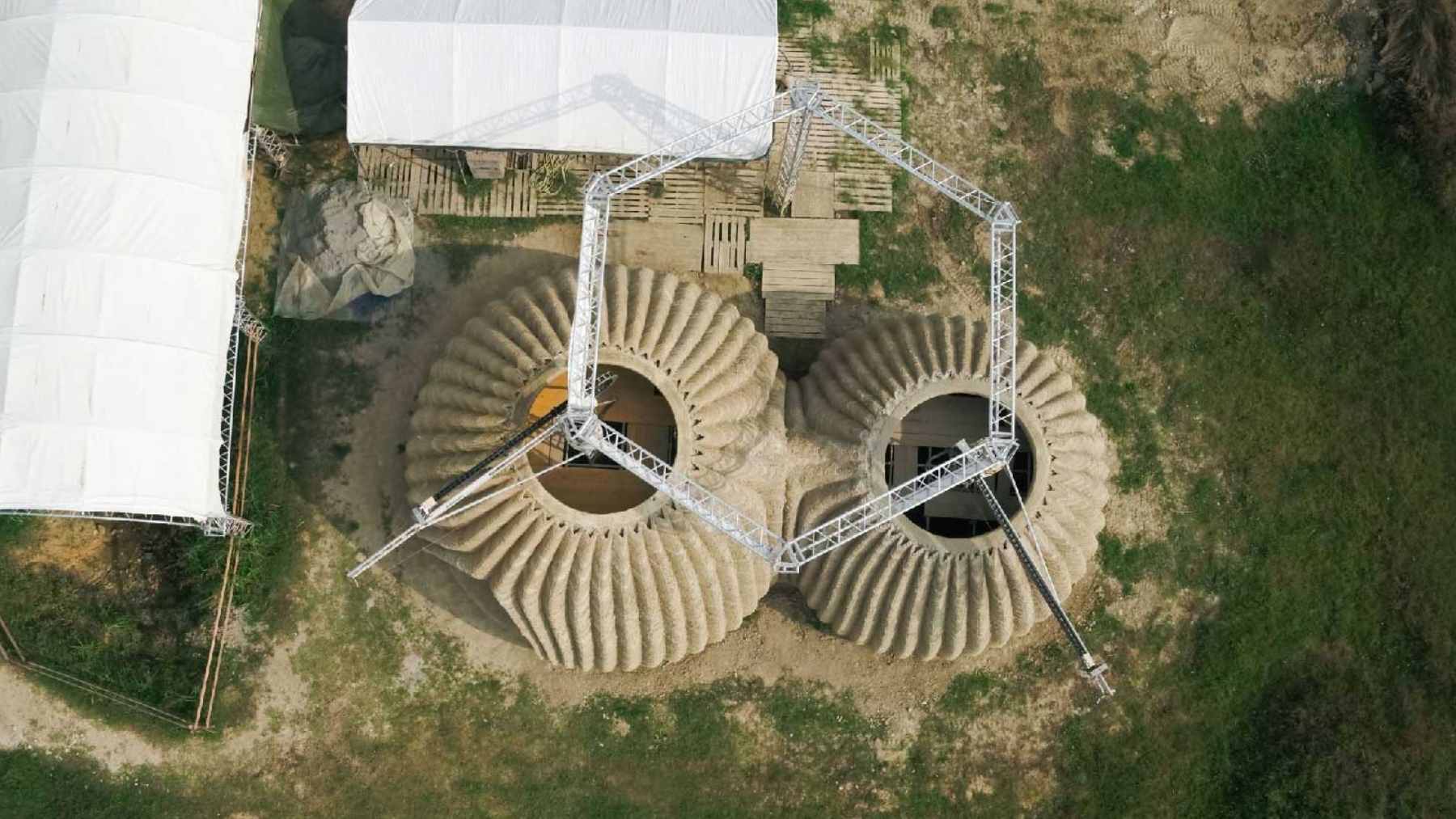 The TECLA 3D-printed housing prototype in Italy, showcasing its distinct ribbed clay exterior made from locally sourced earth.