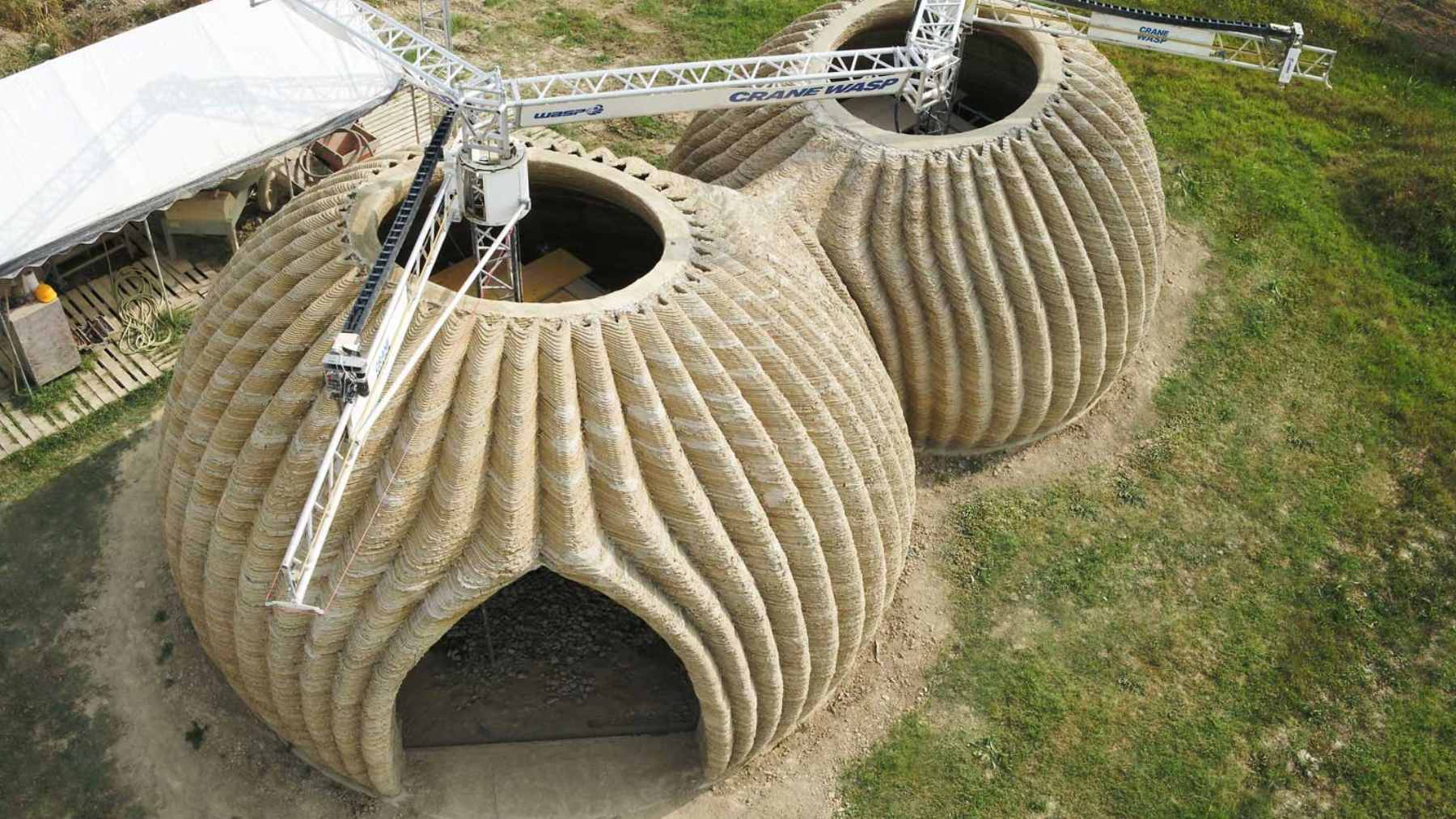 The TECLA 3D-printed housing prototype in Italy, showcasing its distinct ribbed clay exterior made from locally sourced earth.