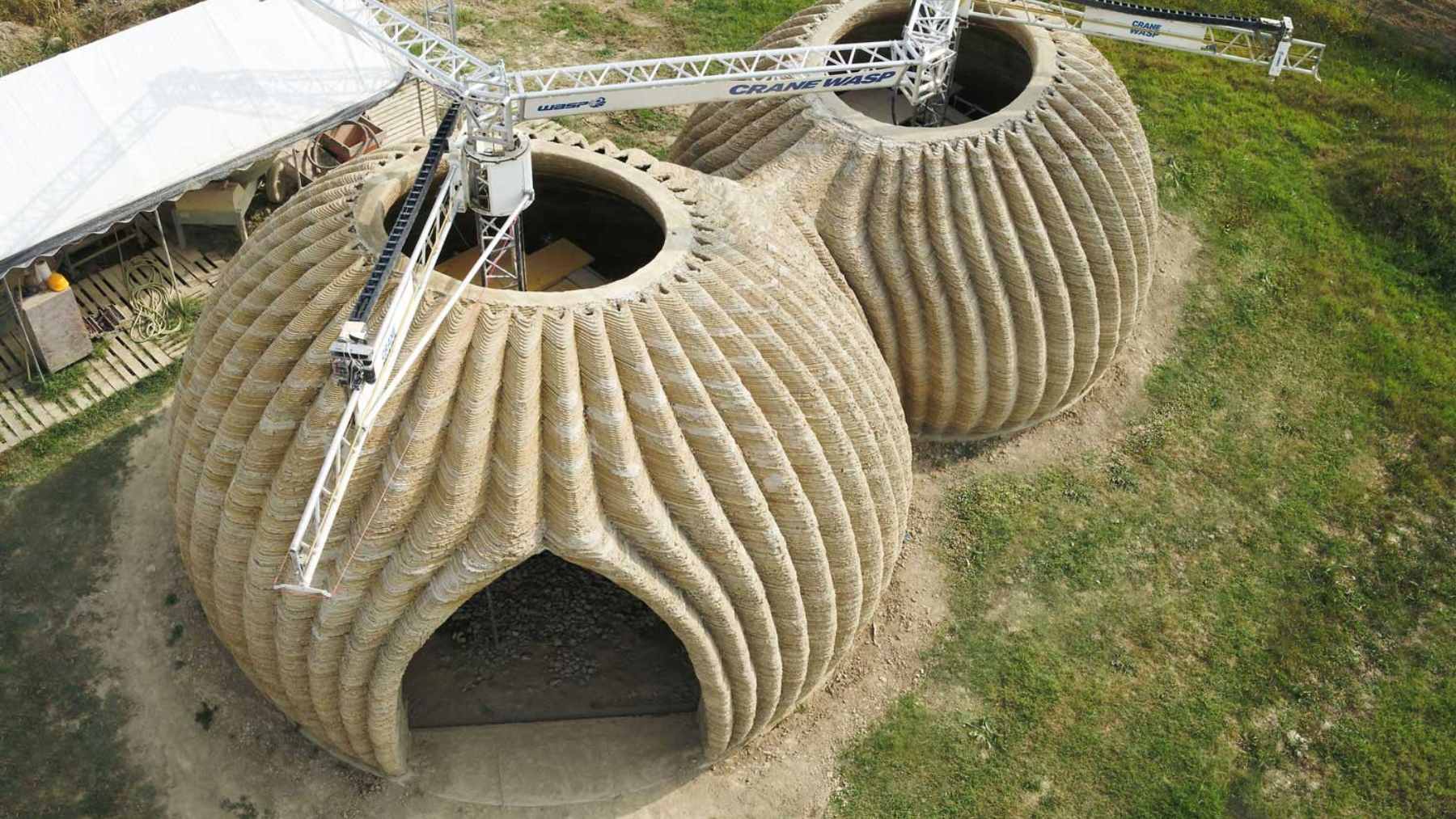 he TECLA 3D-printed earthen house in Italy, featuring its unique rounded, dome-like structure made from raw soil.